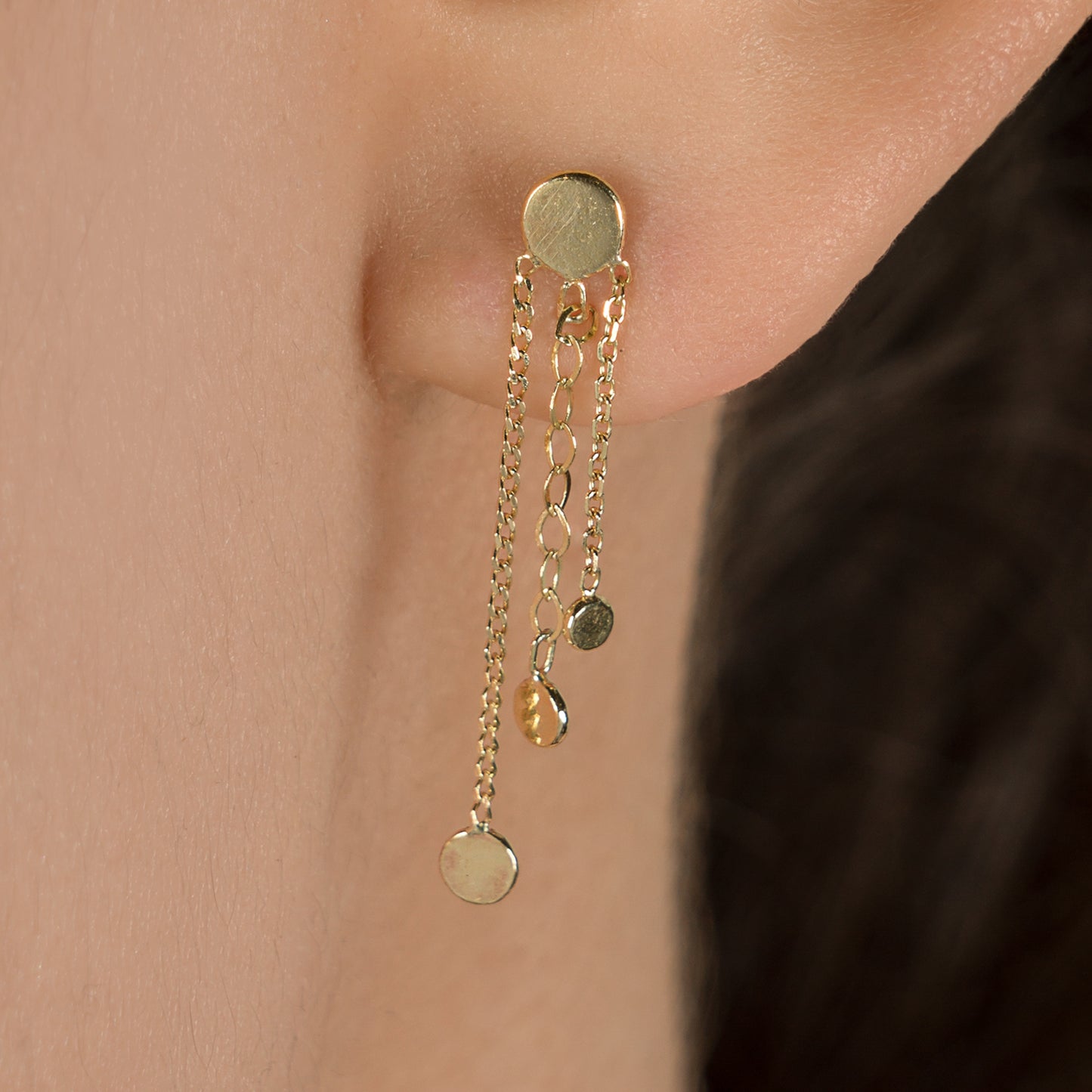 Sweet Pea 18ct gold Ancient Worlds stud earring with chain and disc tassels on model