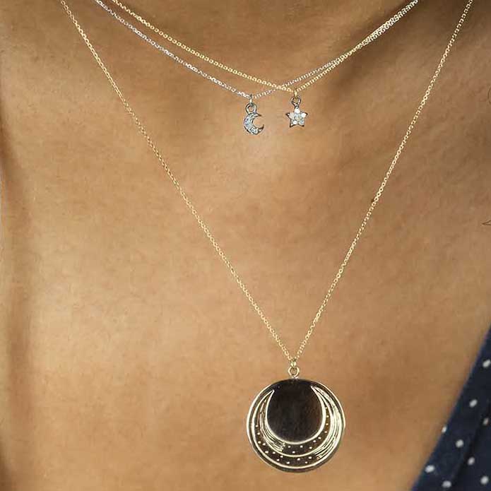 Laura Lee sterling silver Luna Coin engraved pendant on model.