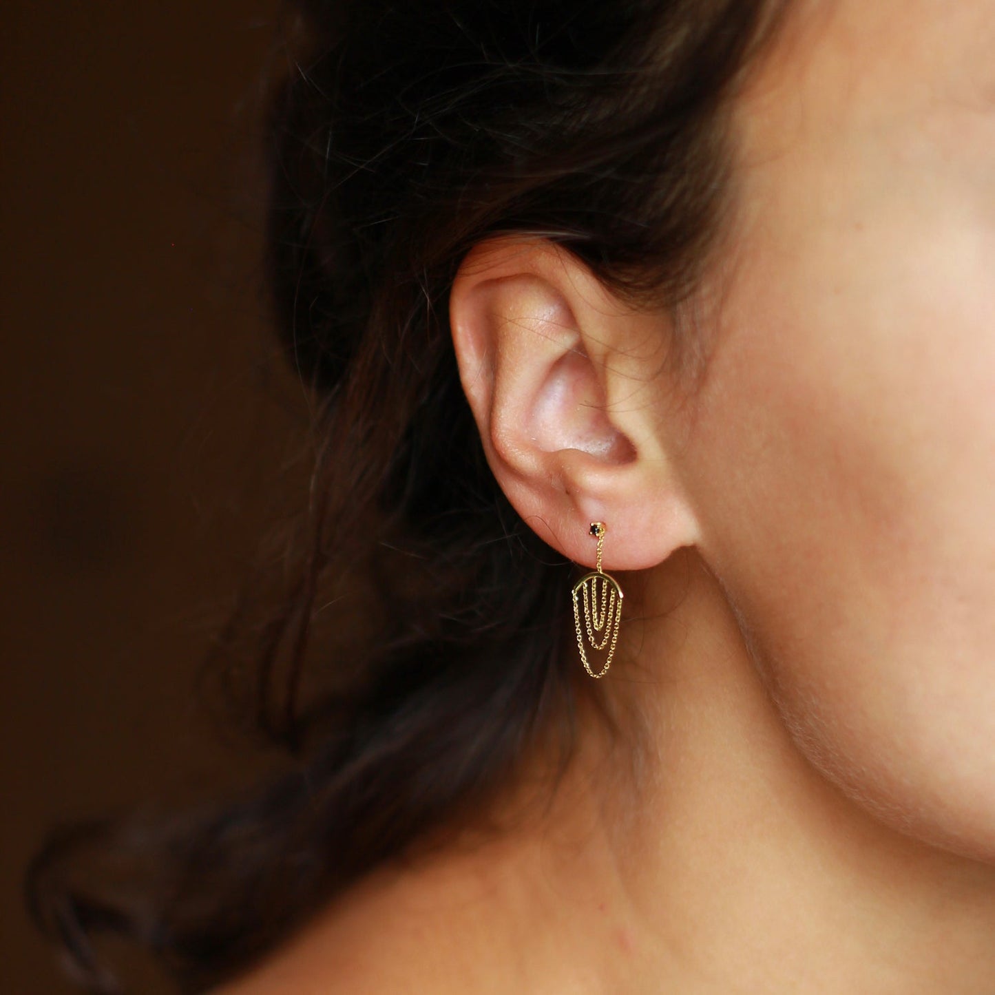 Sweet Pea 18ct yellow gold Nouveau Now black diamond stud earrings with hanging gold arcs with layered chain on model.