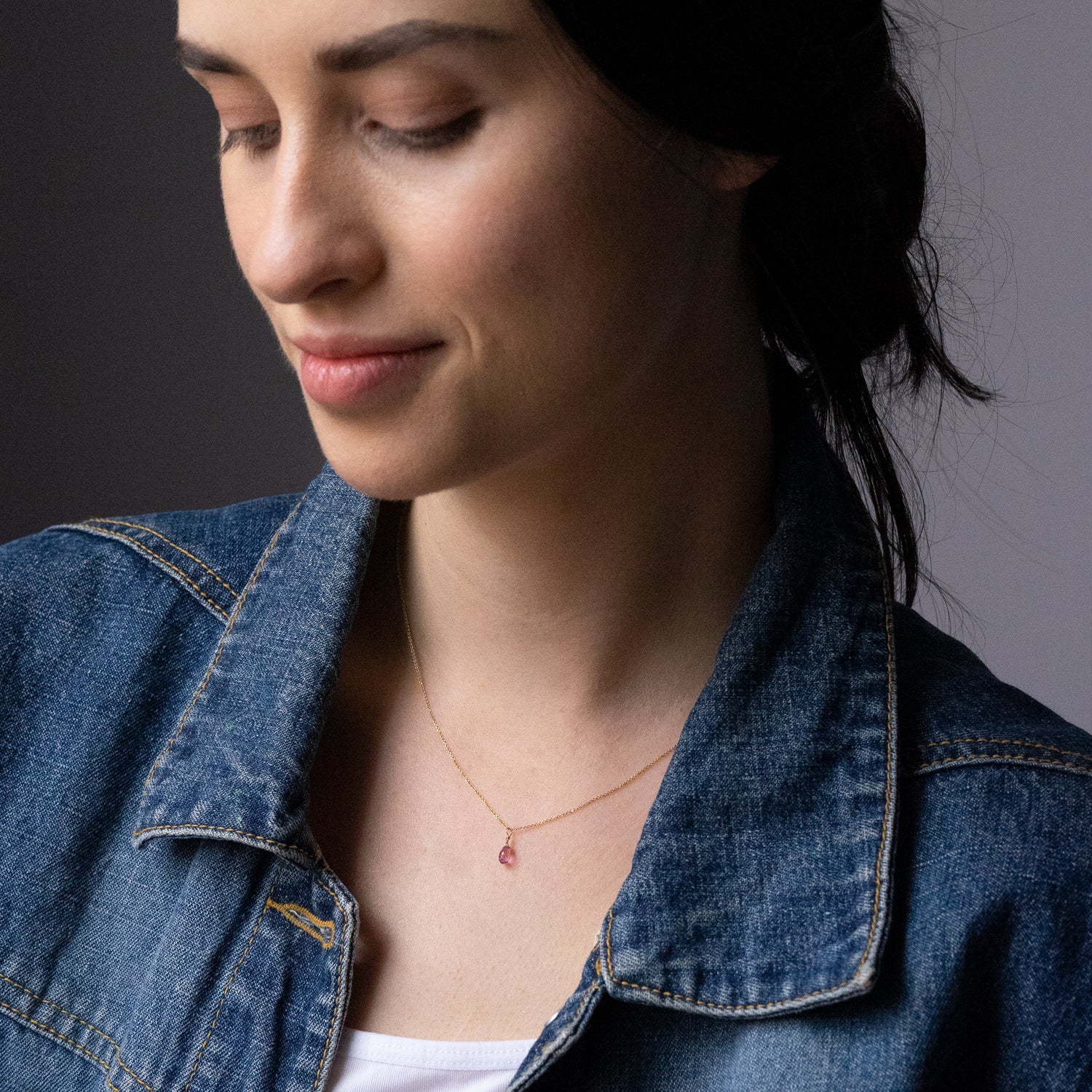 Sweet Pea 18ct yellow gold chain with pink sapphire briolette drop pendant on model. 20% of sale going to Breast Cancer Support