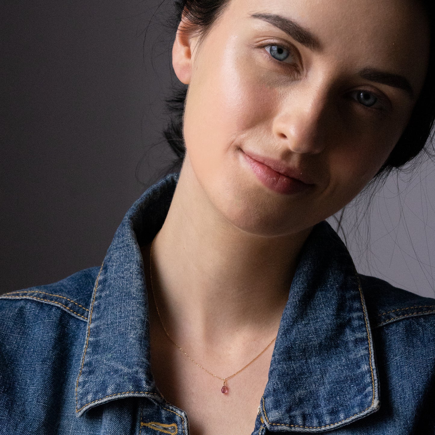 Sweet Pea 18ct yellow gold chain with pink sapphire briolette drop pendant on model. 20% of sale going to Breast Cancer Support