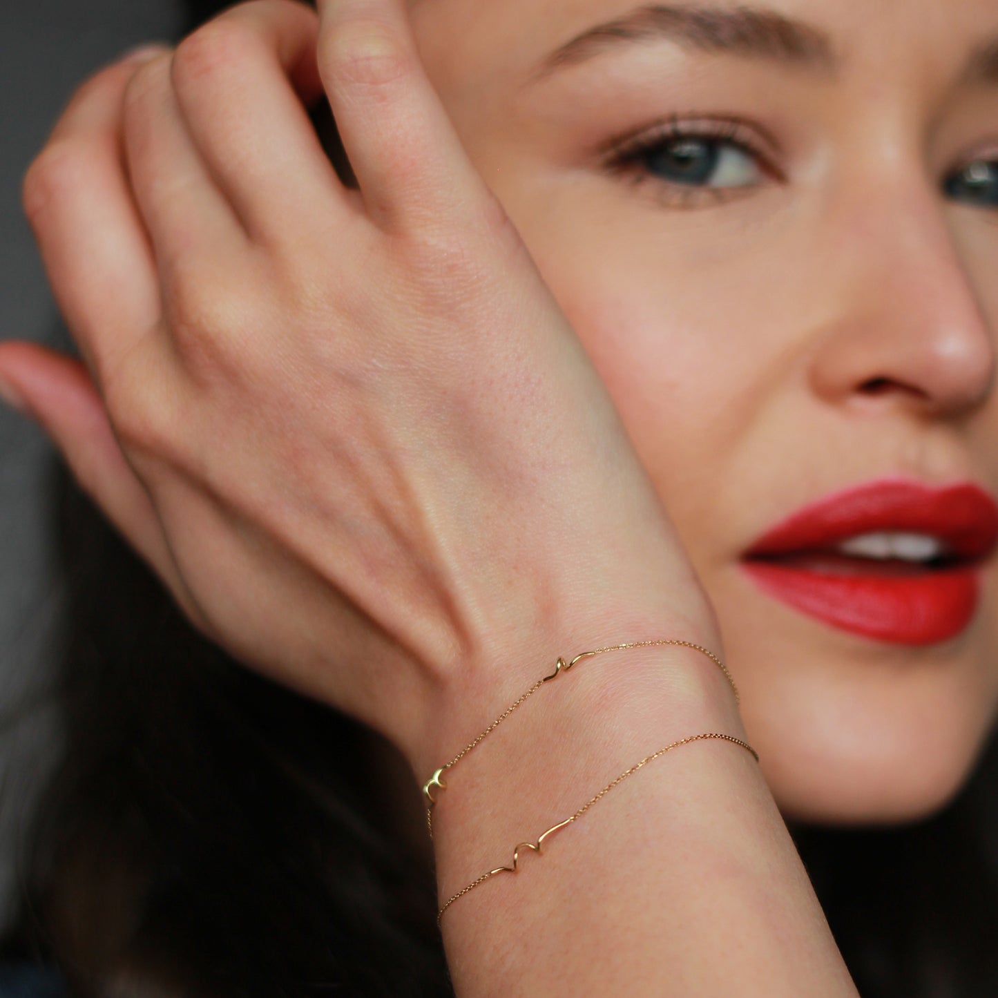 18ct yellow gold fine chain double strand bracelet with 3 inserted Doodles on model