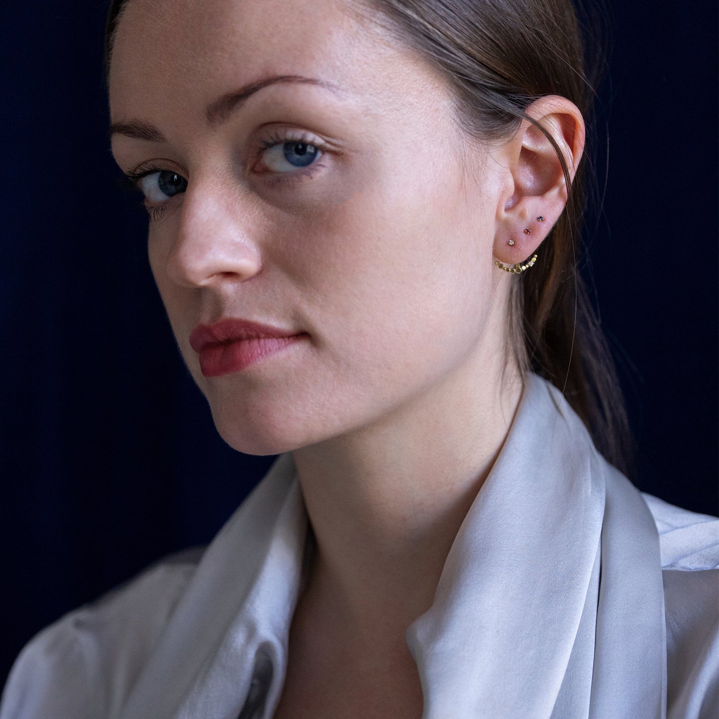 18ct yellow gold Ruby studs on model