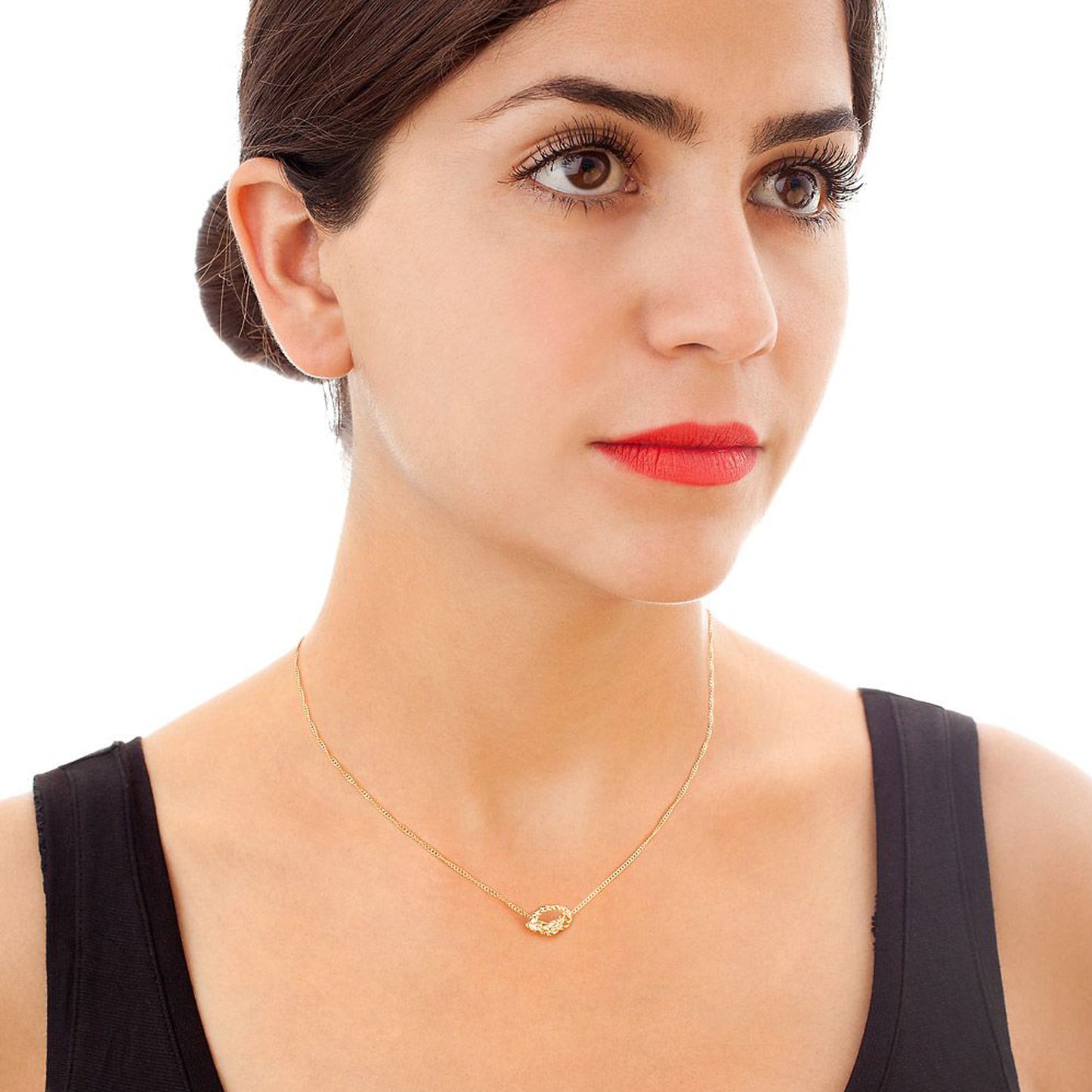 Kerry Huff knot necklace shown worn with rose gold rope texture pendant