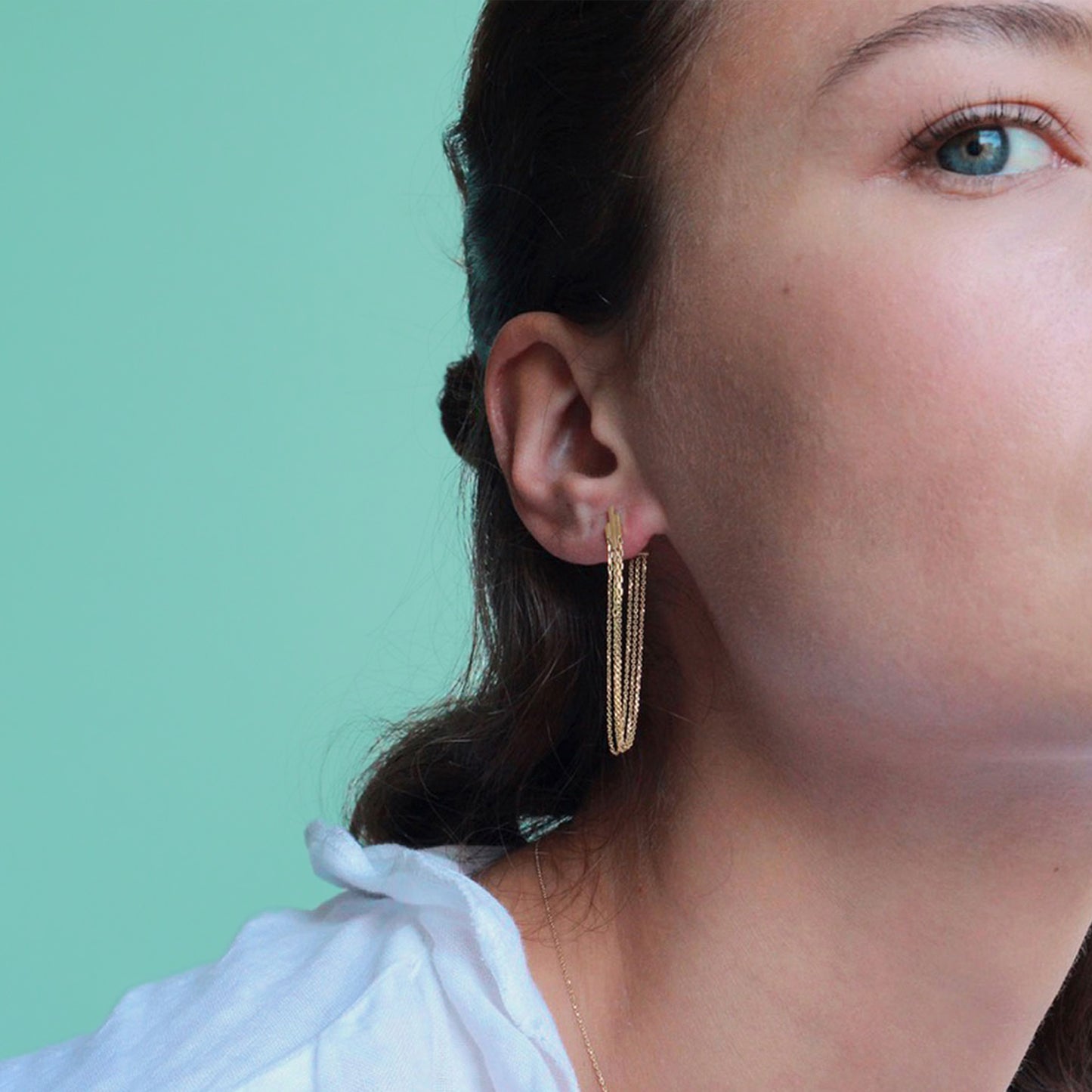 DECO DECADENCE STUDS WITH LAYERED CHAINS ON MODEL