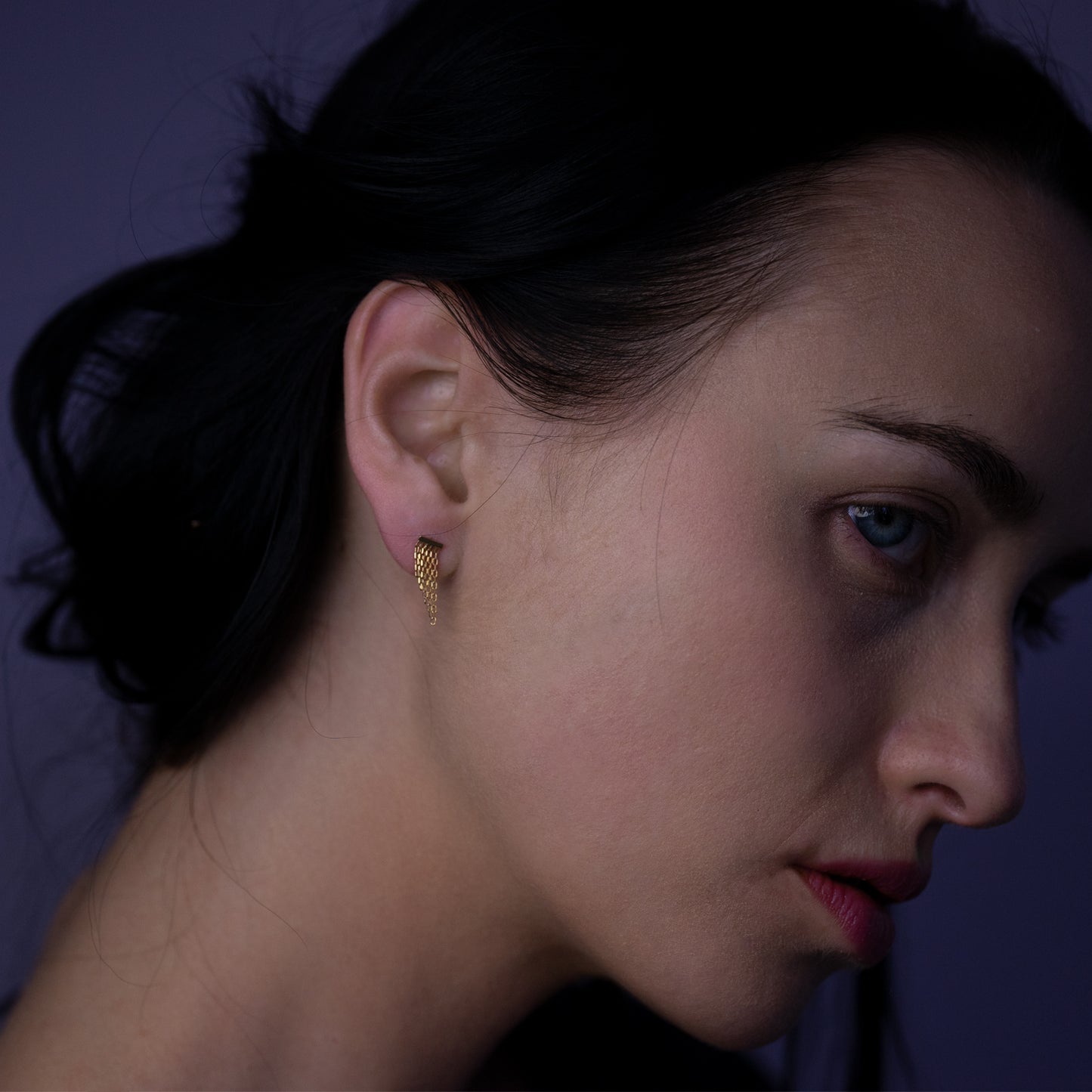 18ct yellow gold small studs with sloped fringe on model