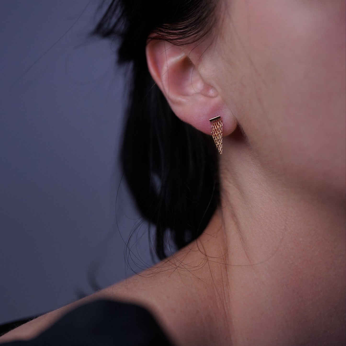 18ct yellow gold small studs with sloped fringe on model