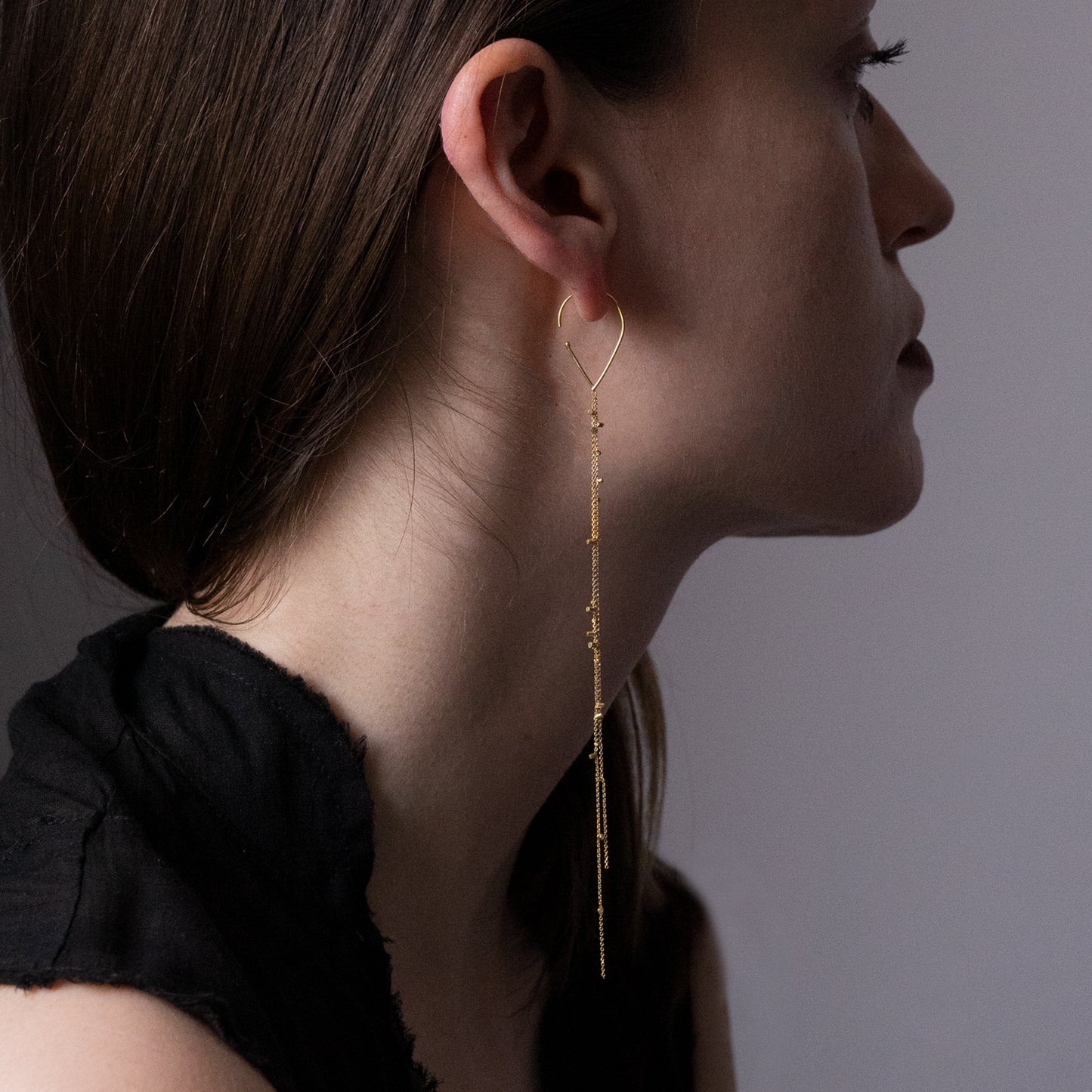 These fabulous hook earrings are part of our Gold Dust Collection. The Hooks have two strands of 18ct yellow fine chain sprinkled with a shimmering of gold embellishments on model