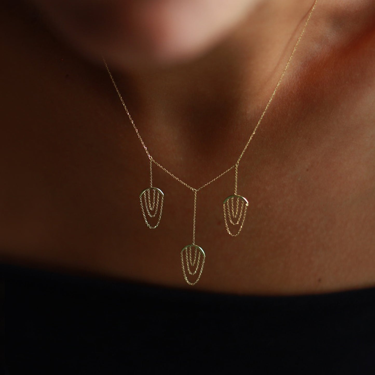 Sweet Pea 18ct yellow gold Nouveau Now triple drop necklace with looped chains on model.