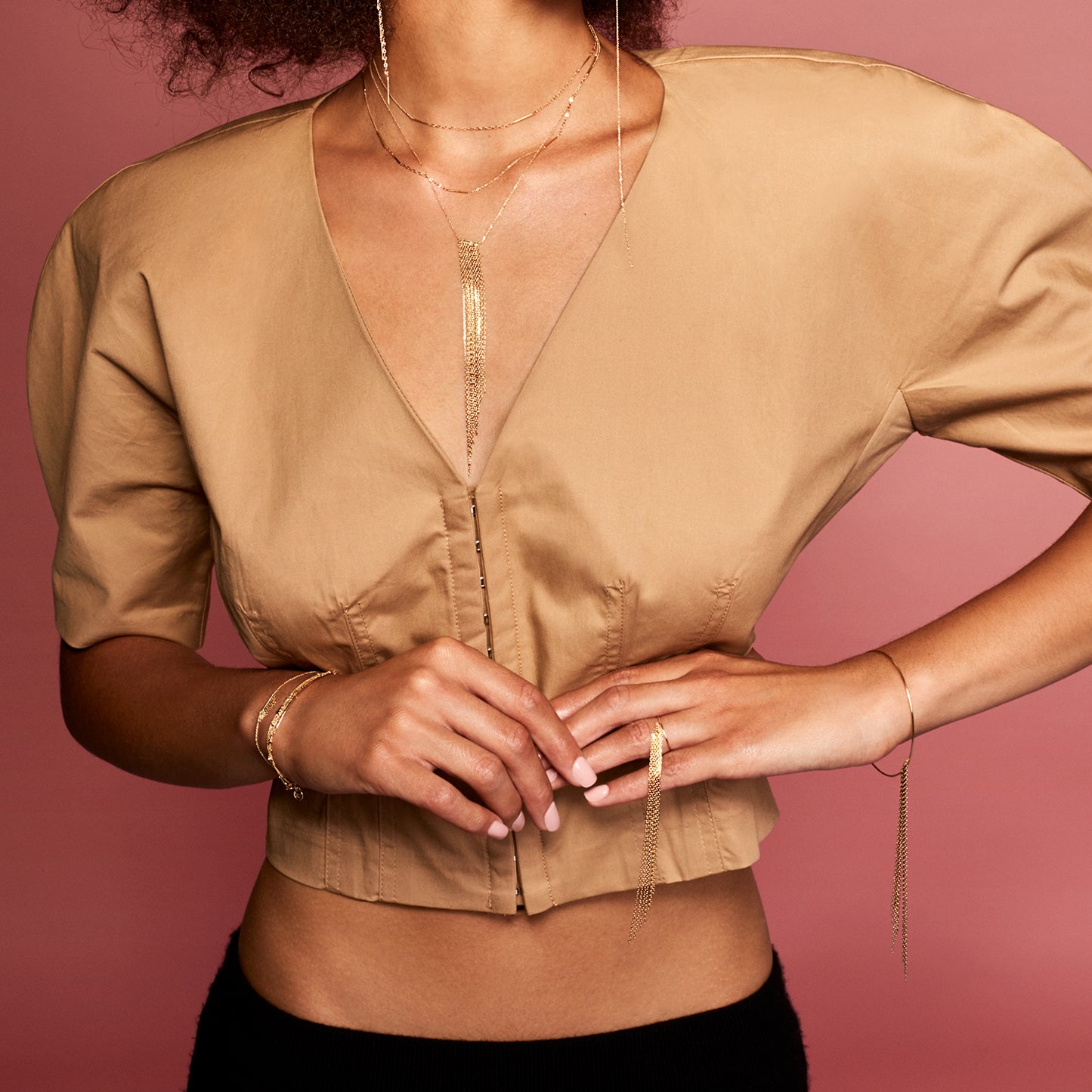 18ct yellow gold ring with long tapered fringe bangle on model