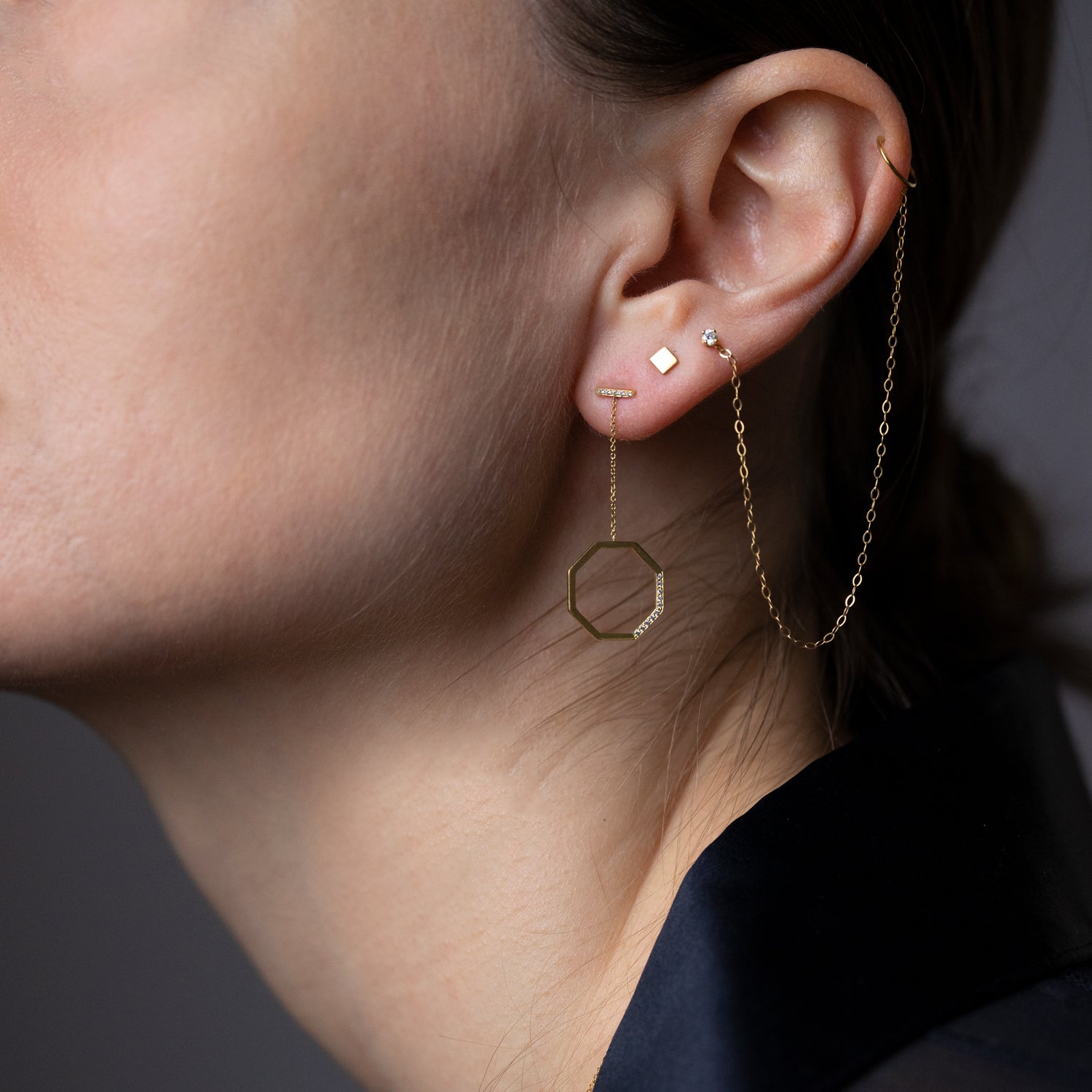 18ct yellow gold octagon drop earrings with Diamond set bar studs and hanging solid gold octagon shape pave set with 15 Diamonds on model