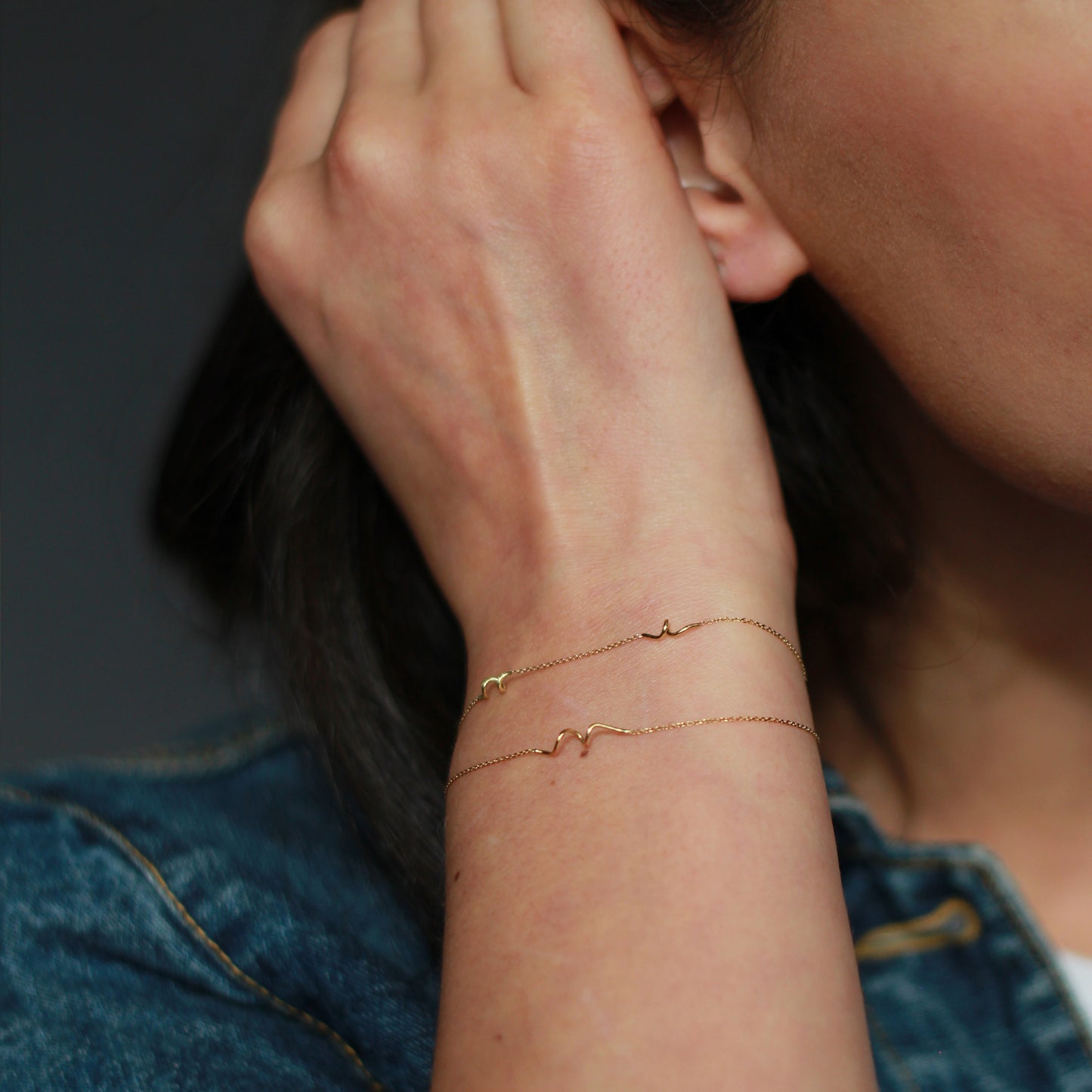 18ct yellow gold fine chain double strand bracelet with 3 inserted Doodles on model