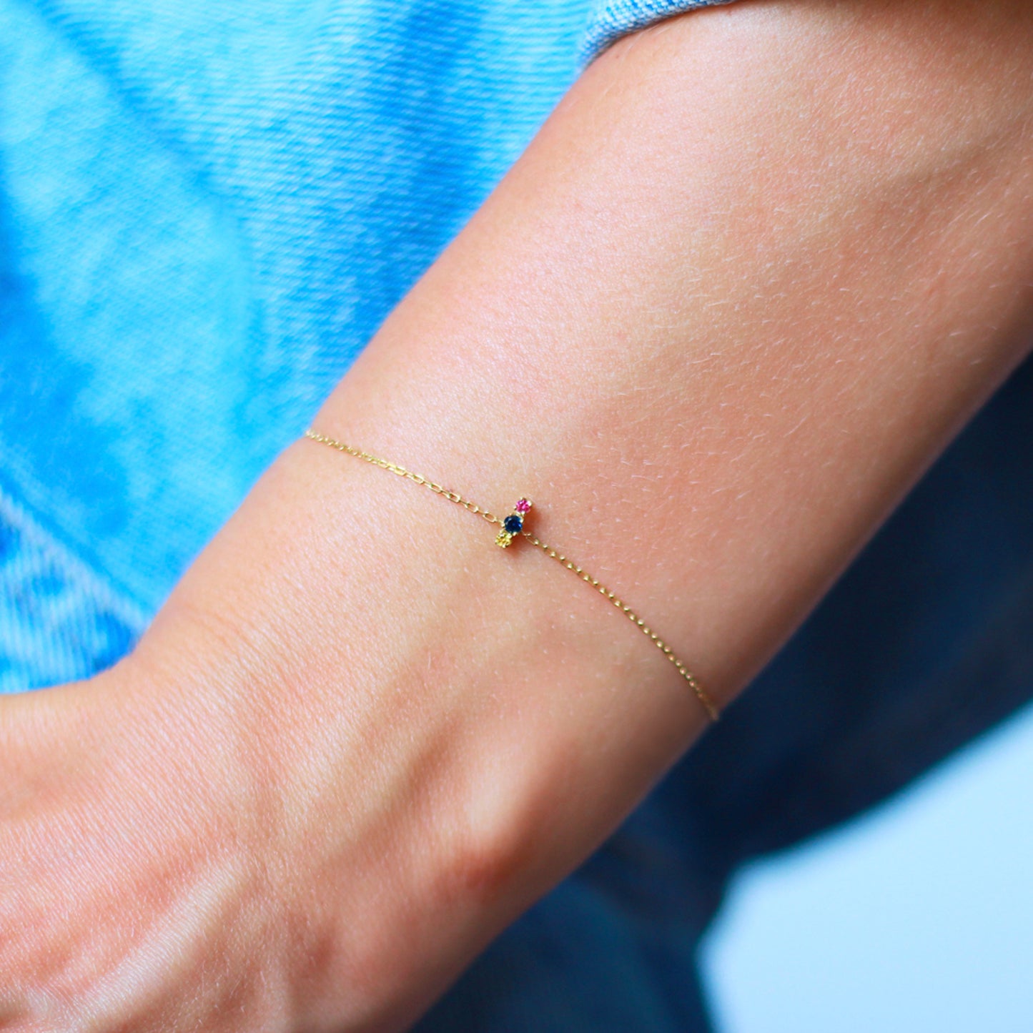 18ct yellow gold chain bracelet with set pink blue and yellow Sapphires on model
