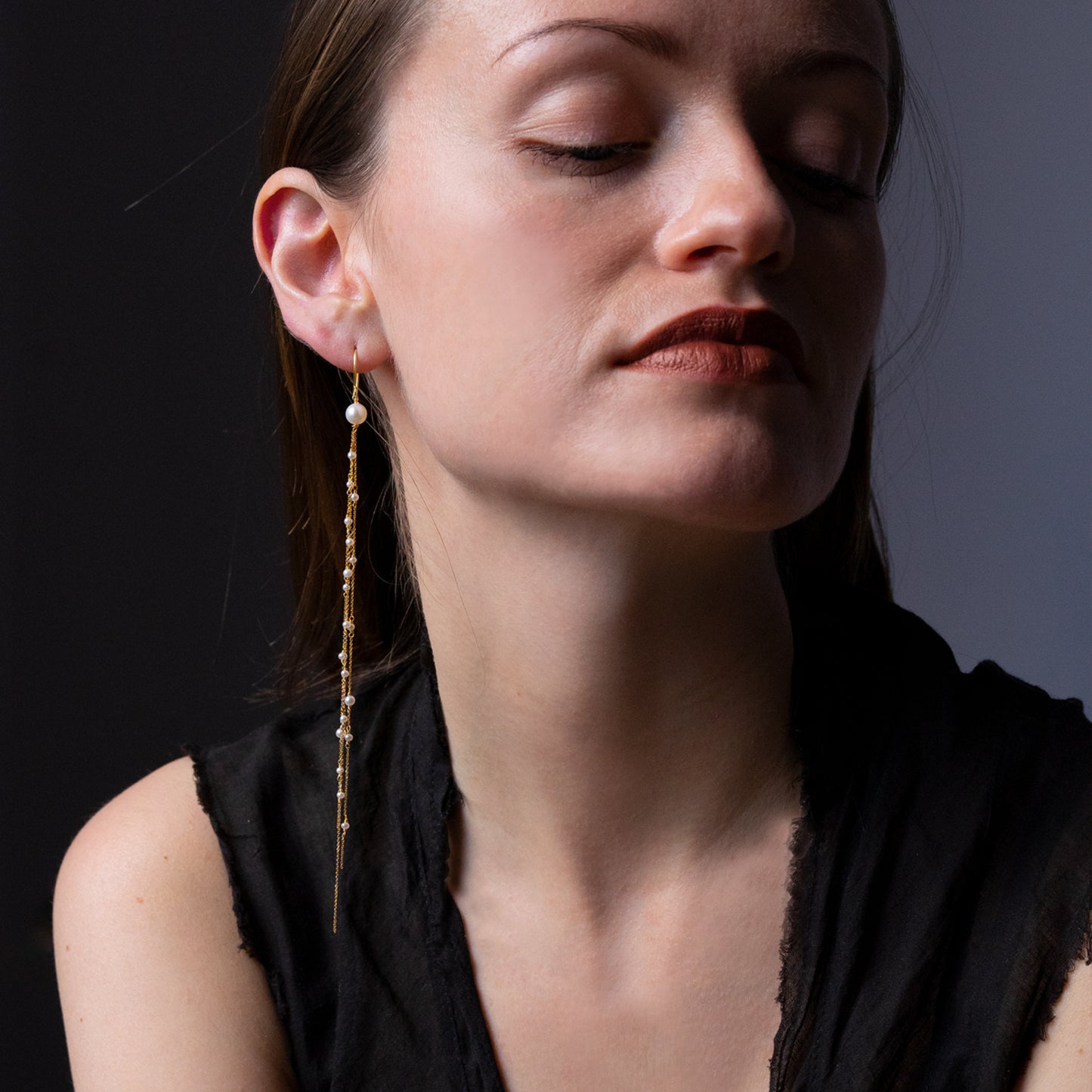 18ct yellow gold fine hook earring with 3 strands of the fine chain and seed pearls on model