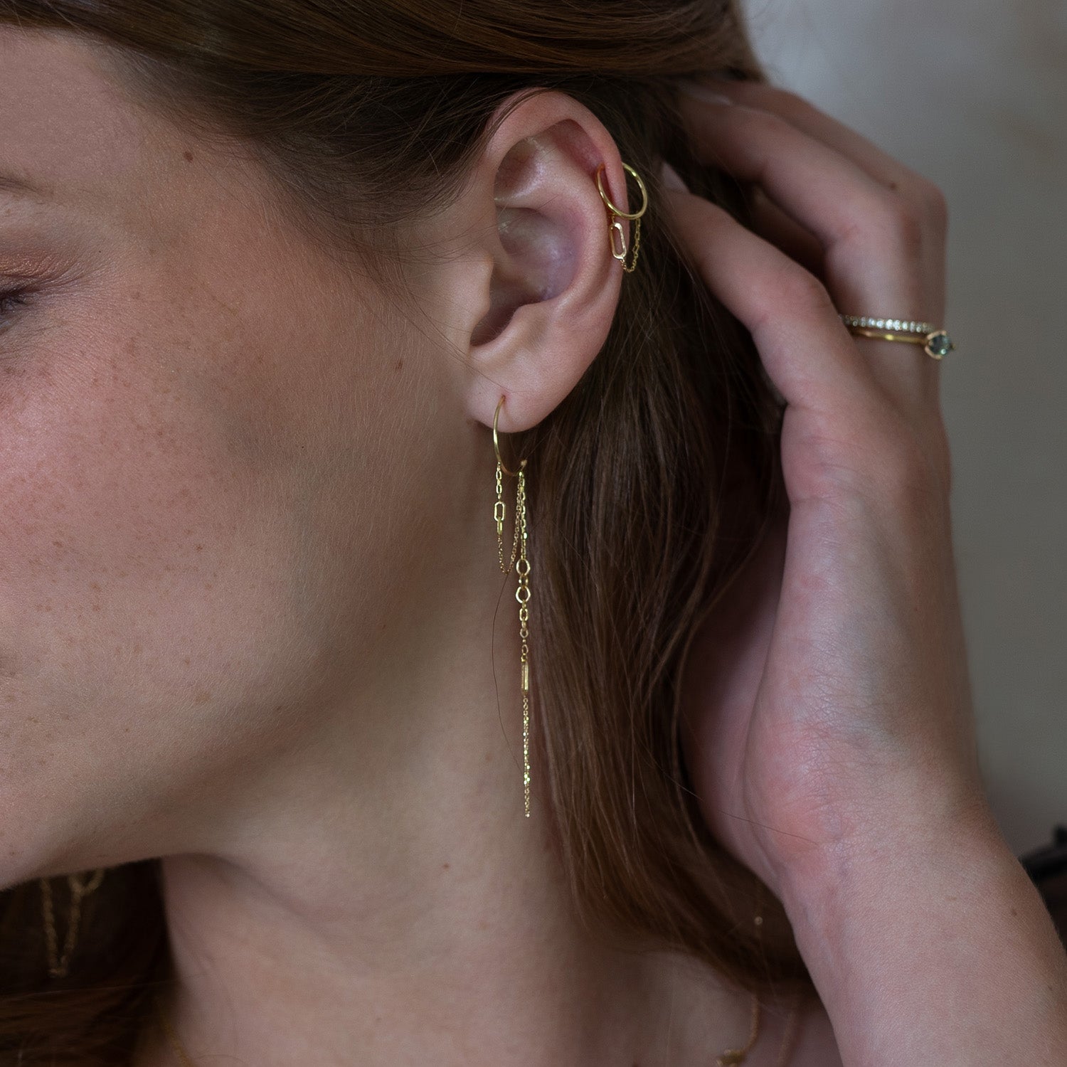 18ct Gold Chains Galore dangling baby hoops looped with hanging chains on model