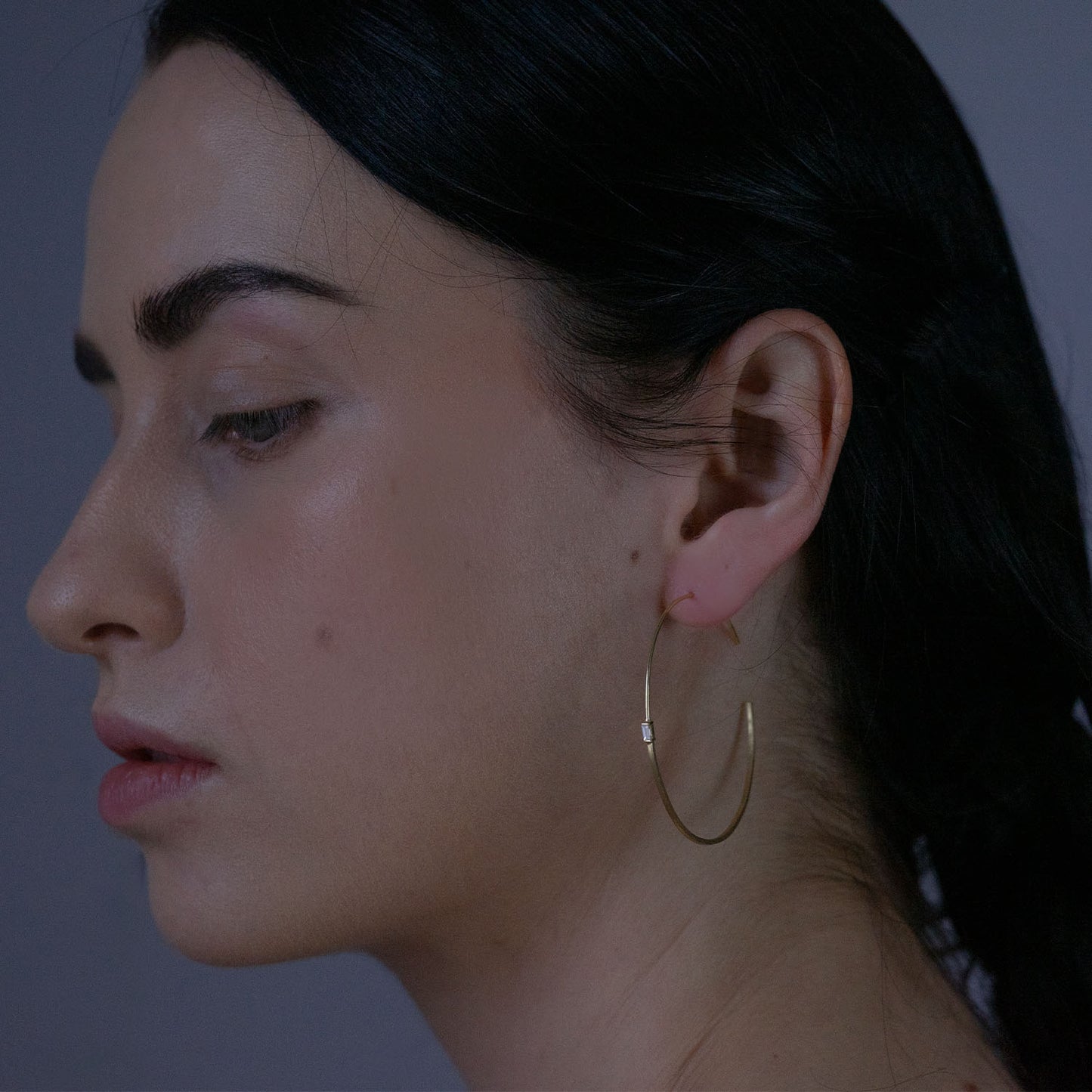 18ct Gold medium half/half hoop earrings with baguette Diamonds on model