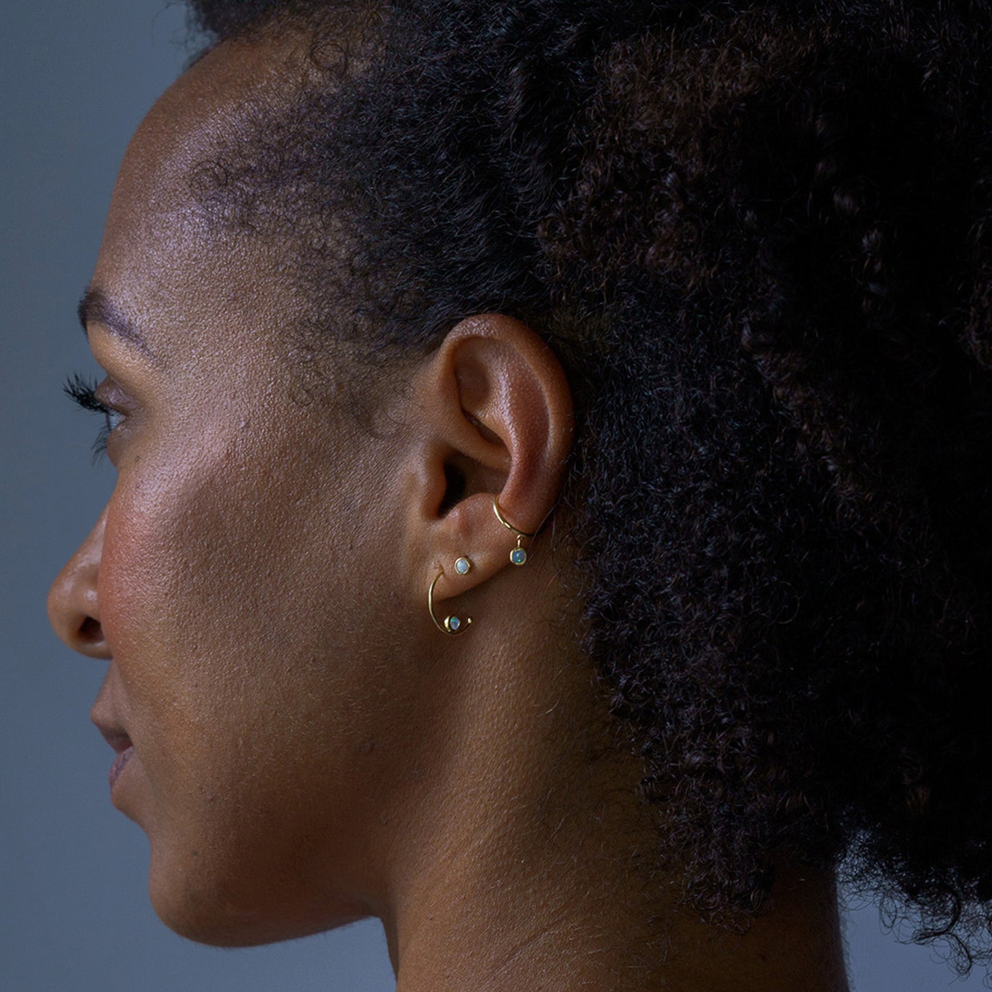 gold and opal ear cuff earring on model