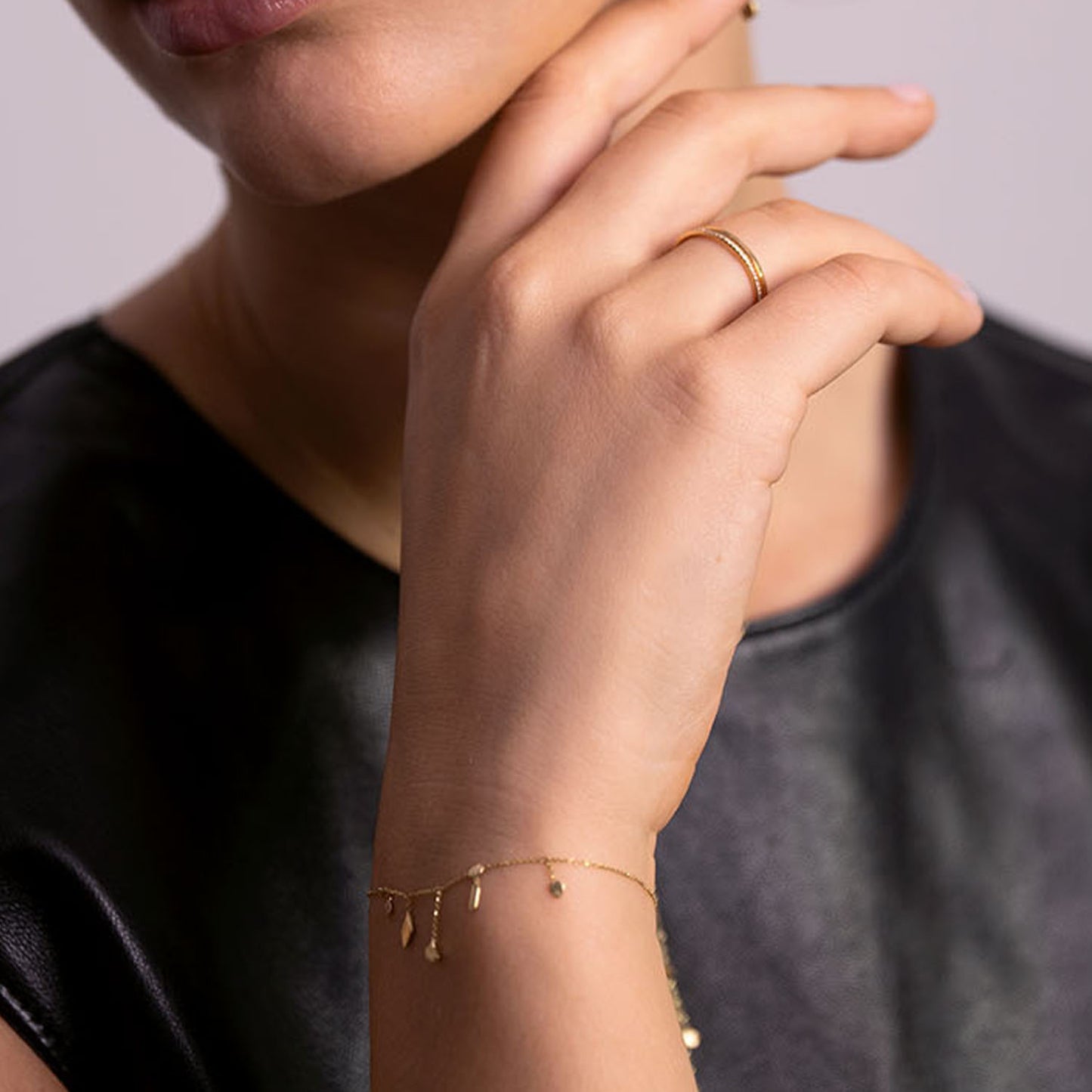 18ct Gold fine cain necklace with claw set pink Sapphire and double gold leaf pendant on model