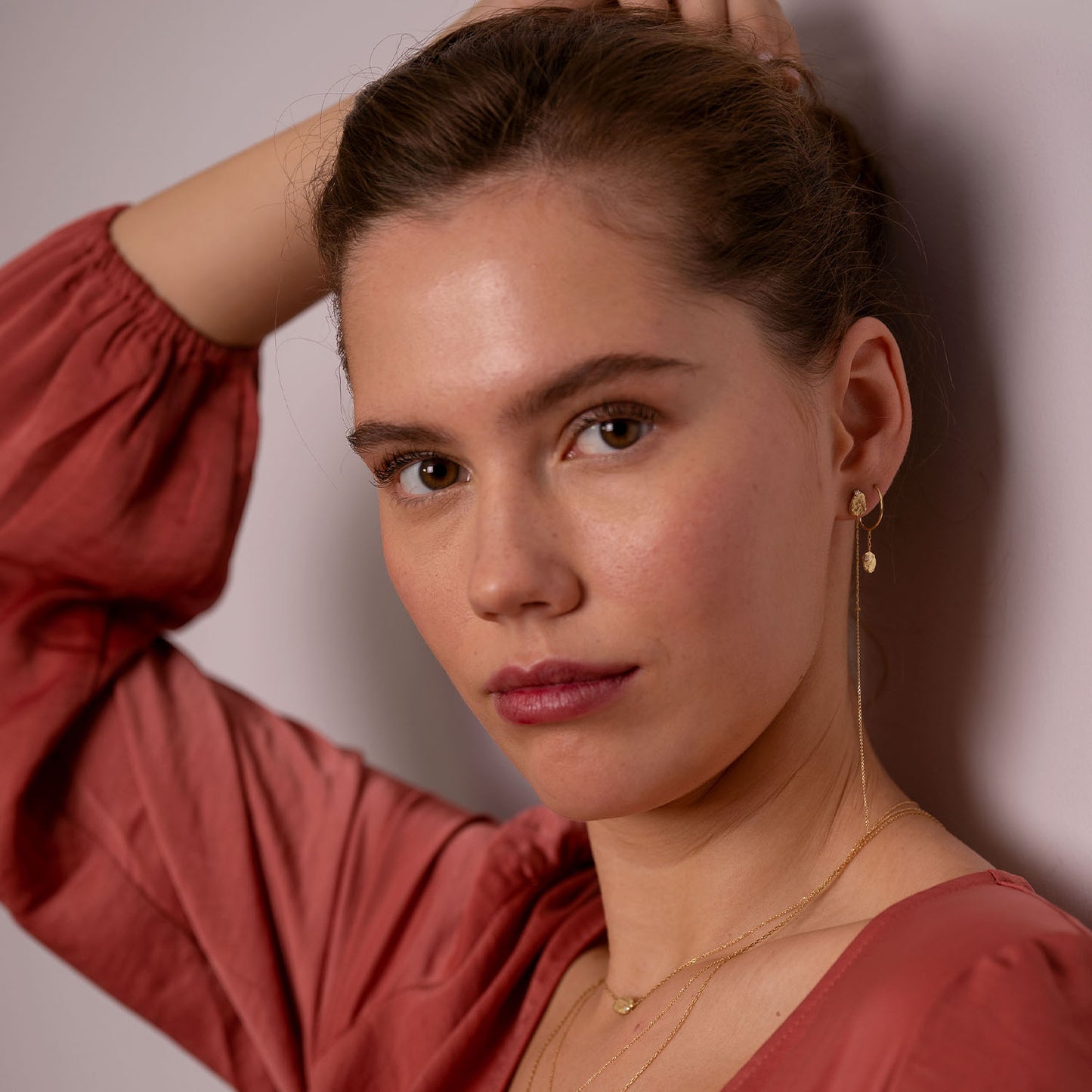 Sweet Pea Moonscape recycled 18ct yellow gold nugget set with white diamond baby hoop earrings on model layered with long moonscape earring.