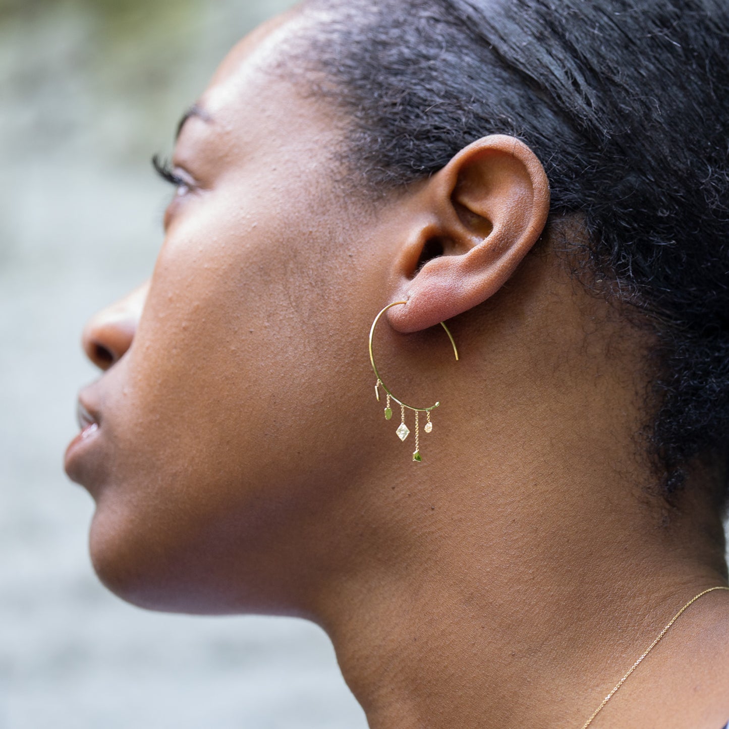 18ct Gold baby hoop with mixed gold shapes on model