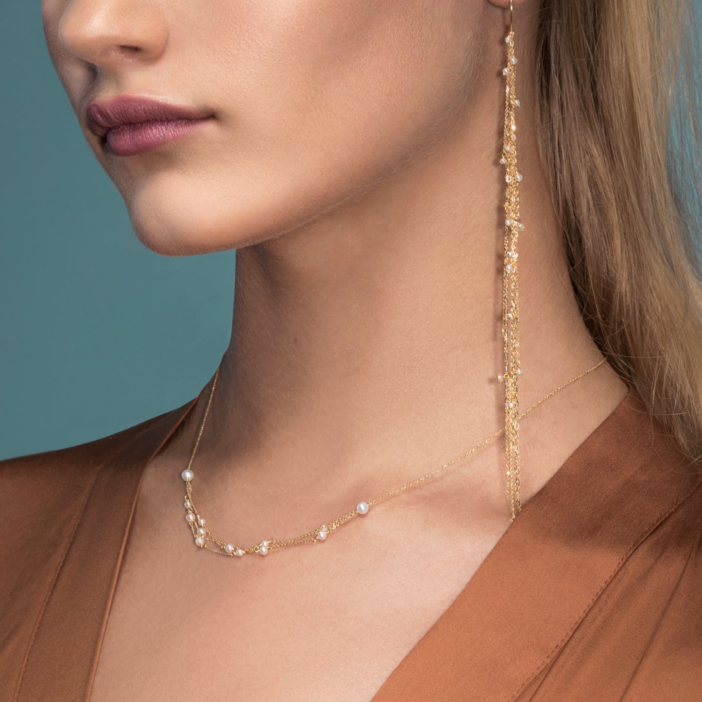 18ct yellow gold fine hook earring with 3 strands of the fine chain and seed pearls on model