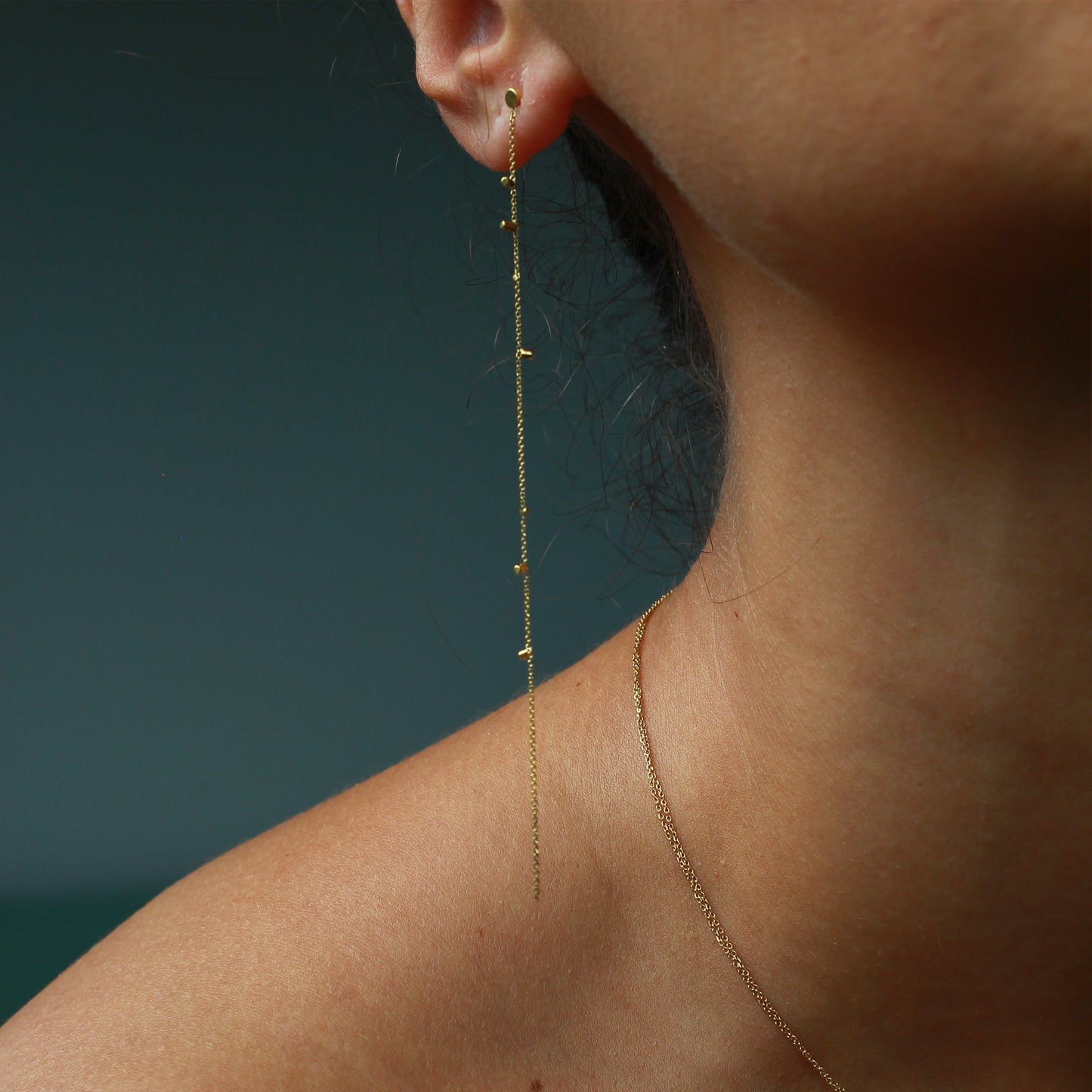 These lovely 18ct yellow single strip earrings sprinkled with a shimmering of gold embellishments are part of our Gold Dust Collection. Glamourous and chic they are the perfect addition to any outfit on model