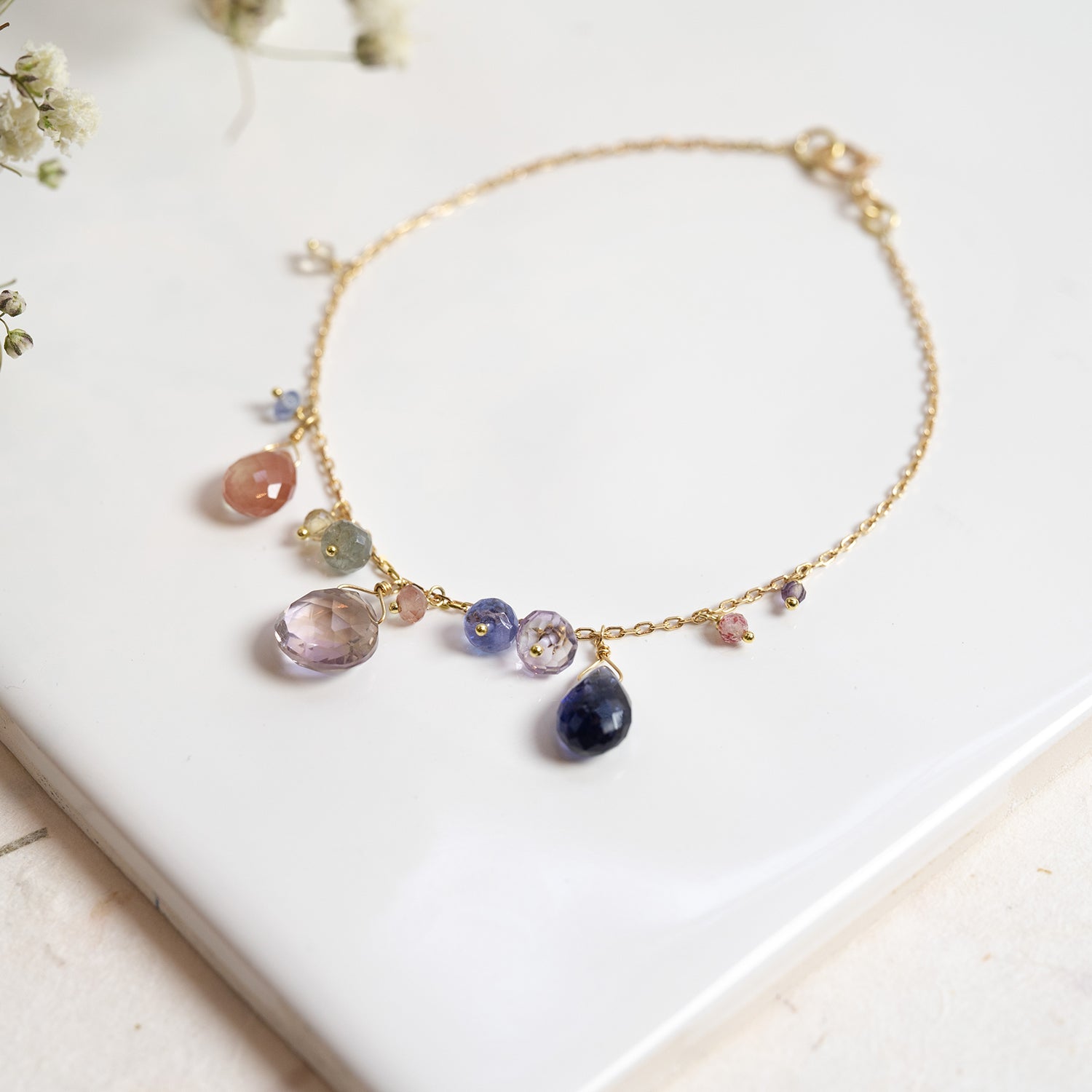 18ct yellow Gold bracelet from our Magic Carpet collection with ametrine, sunstone and iolite drops and a mix of precious beads. 