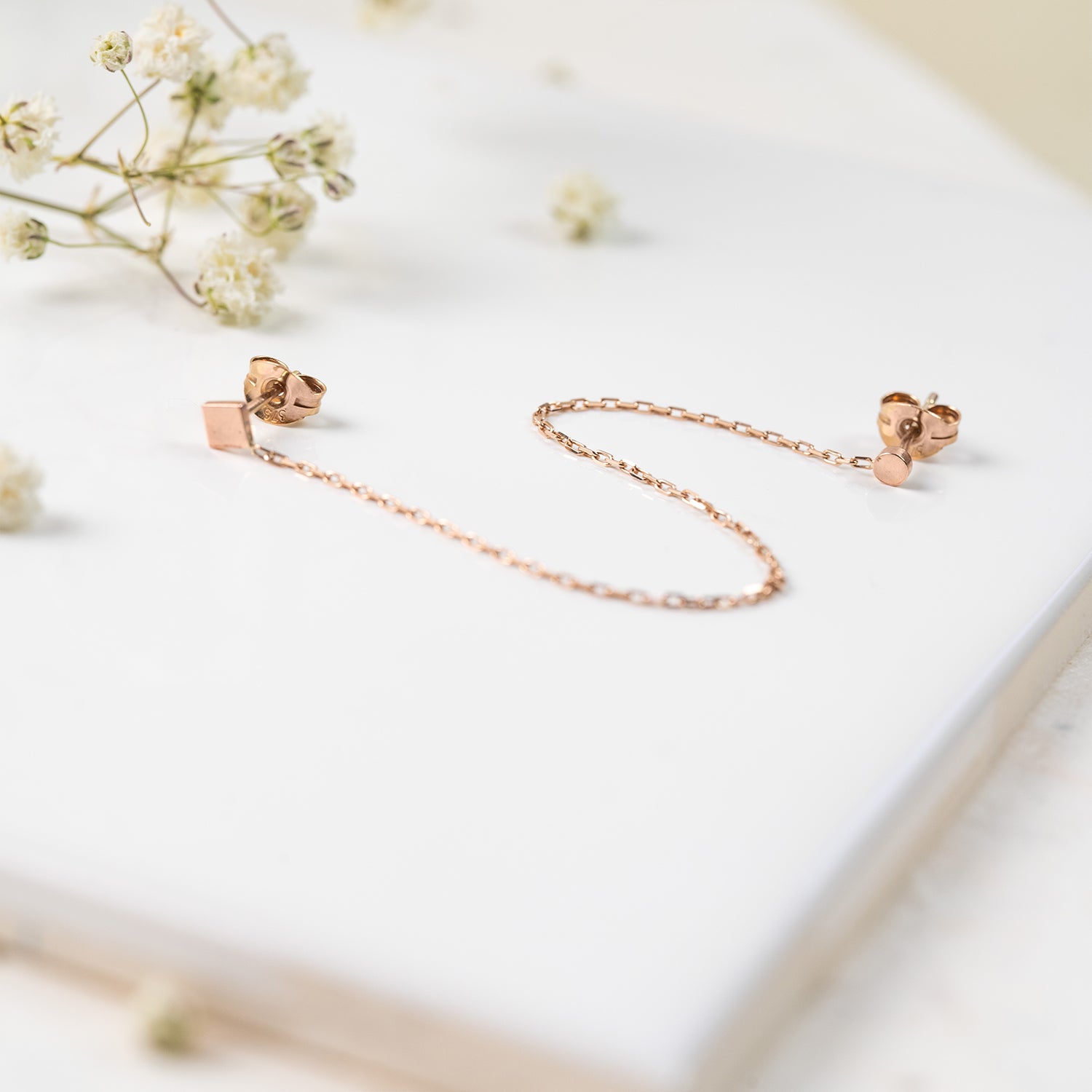 9ct rose gold double stud earring with a round and a square stud.