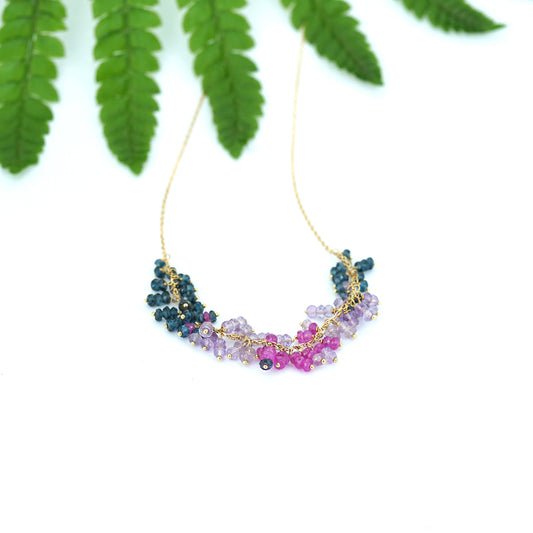 18ct yellow gold chain necklace with beaded front section of London blue topaz, amethyst, pink Amethyst and hot pink sapphire, from our Roses; Violets collection laying flat.