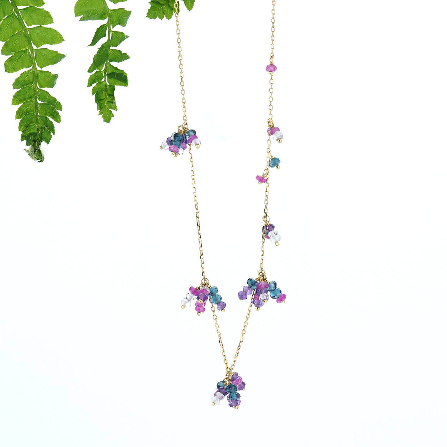 18ct yellow gold chain necklace with beaded clusters of London blue topaz, amethyst, pink Amethyst and hot pink sapphire, from our Roses & Violets collection hanging