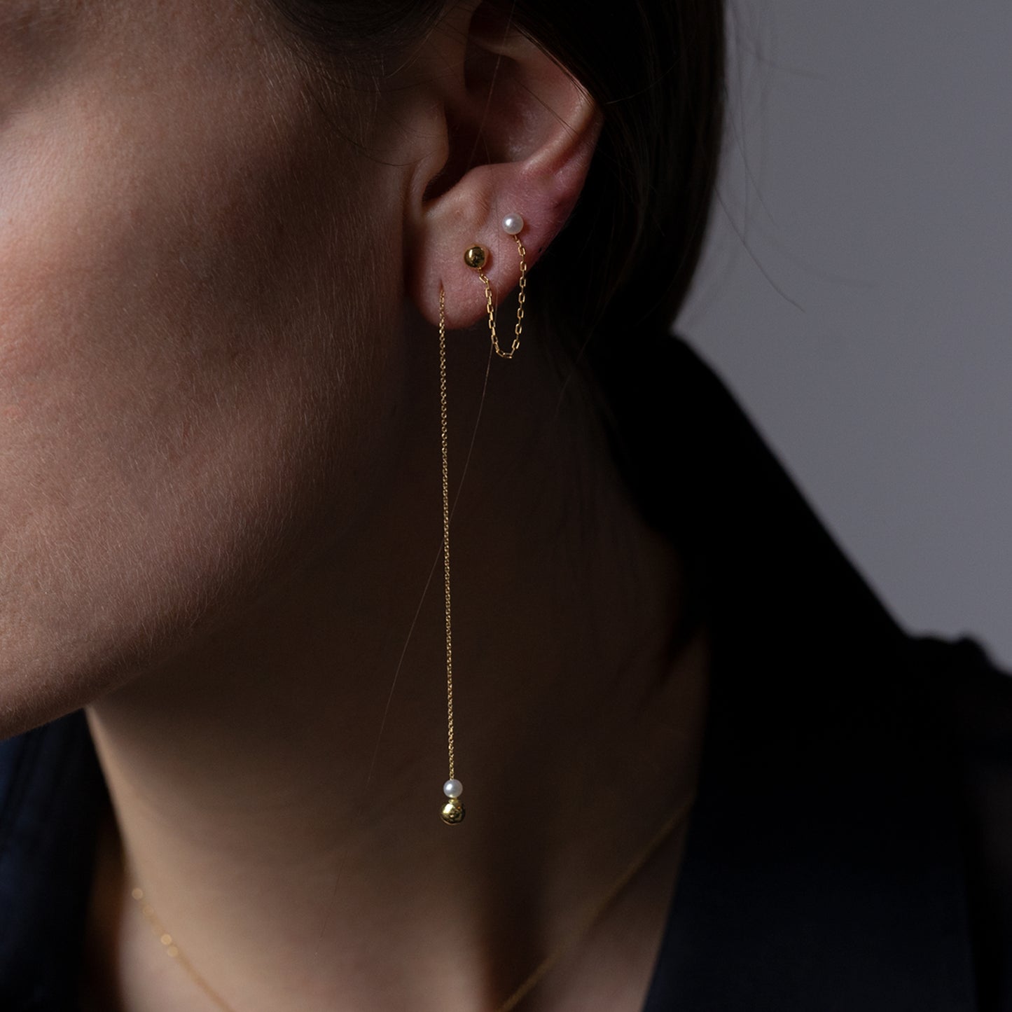 Pearl and Golden Ball Thread Through Earrings on model