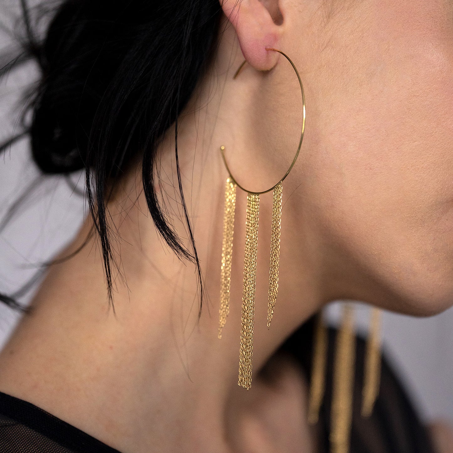 18ct yellow gold large hoop with three hanging fringes on model