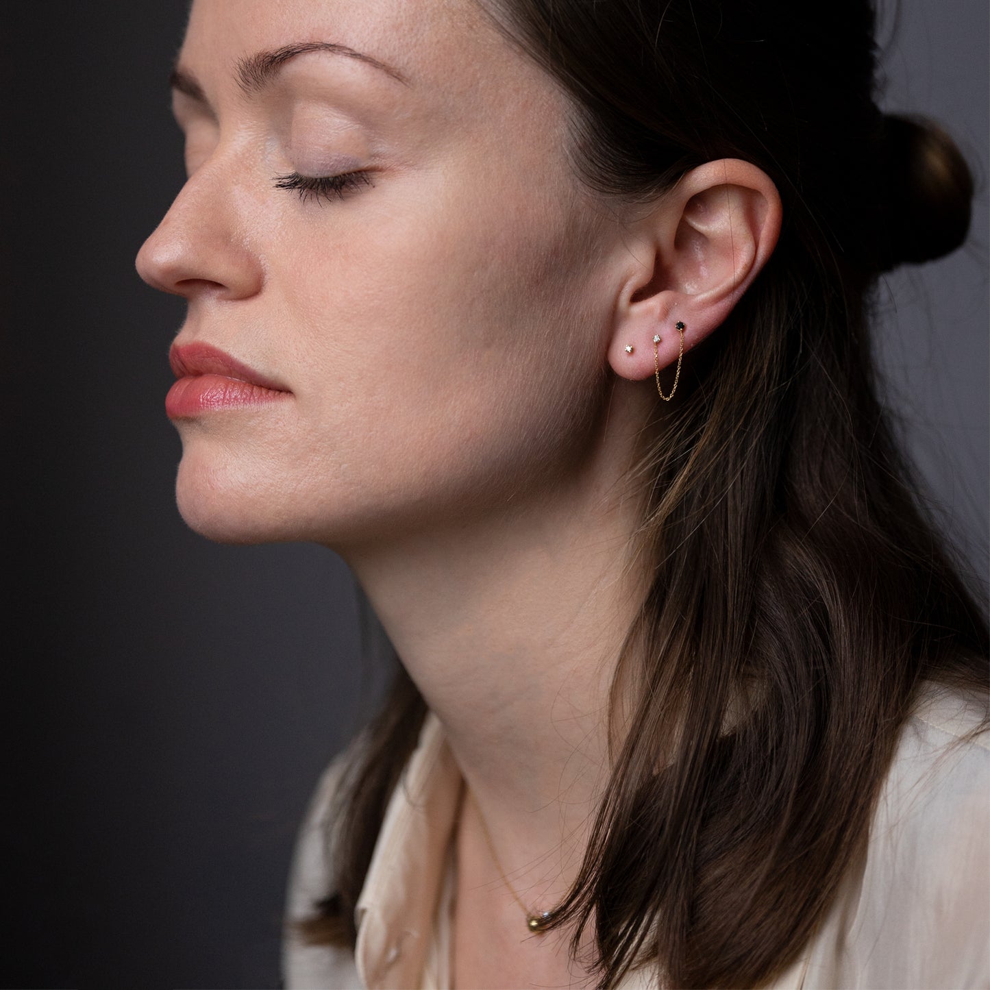 18ct yellow gold double earring with Black Diamond and White Diamond on model