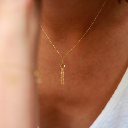 18ct yellow gold Take A Bow necklace with a single circle layered with glistening hanging chains.