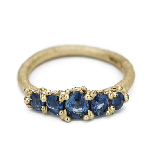 14ct brushed yellow gold Ruth Tomlinson ring set with 5 blue Sapphires surrounded by granulation beads. Alternative engagement ring.