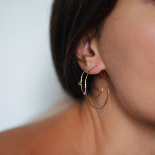 18ct yellow gold hoops with a set pink sapphire on the front, a cute pop of colour on a classic hoop earring on model