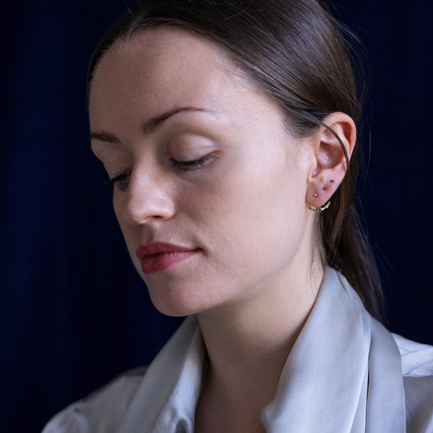 18ct yellow gold Ruby studs on model