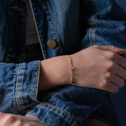 18ct yellow gold bracelet with multi strand section and precious stones  on model