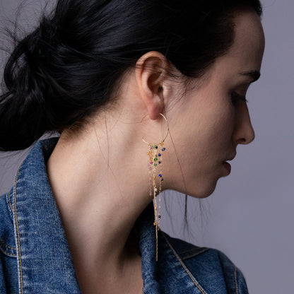 18ct yellow gold medium hoop earrings with hanging chains and mixed precious stones on model