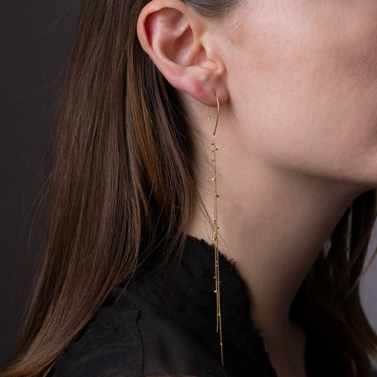 These fabulous hook earrings are part of our Gold Dust Collection. The Hooks have two strands of 18ct yellow fine chain sprinkled with a shimmering of gold embellishments on model