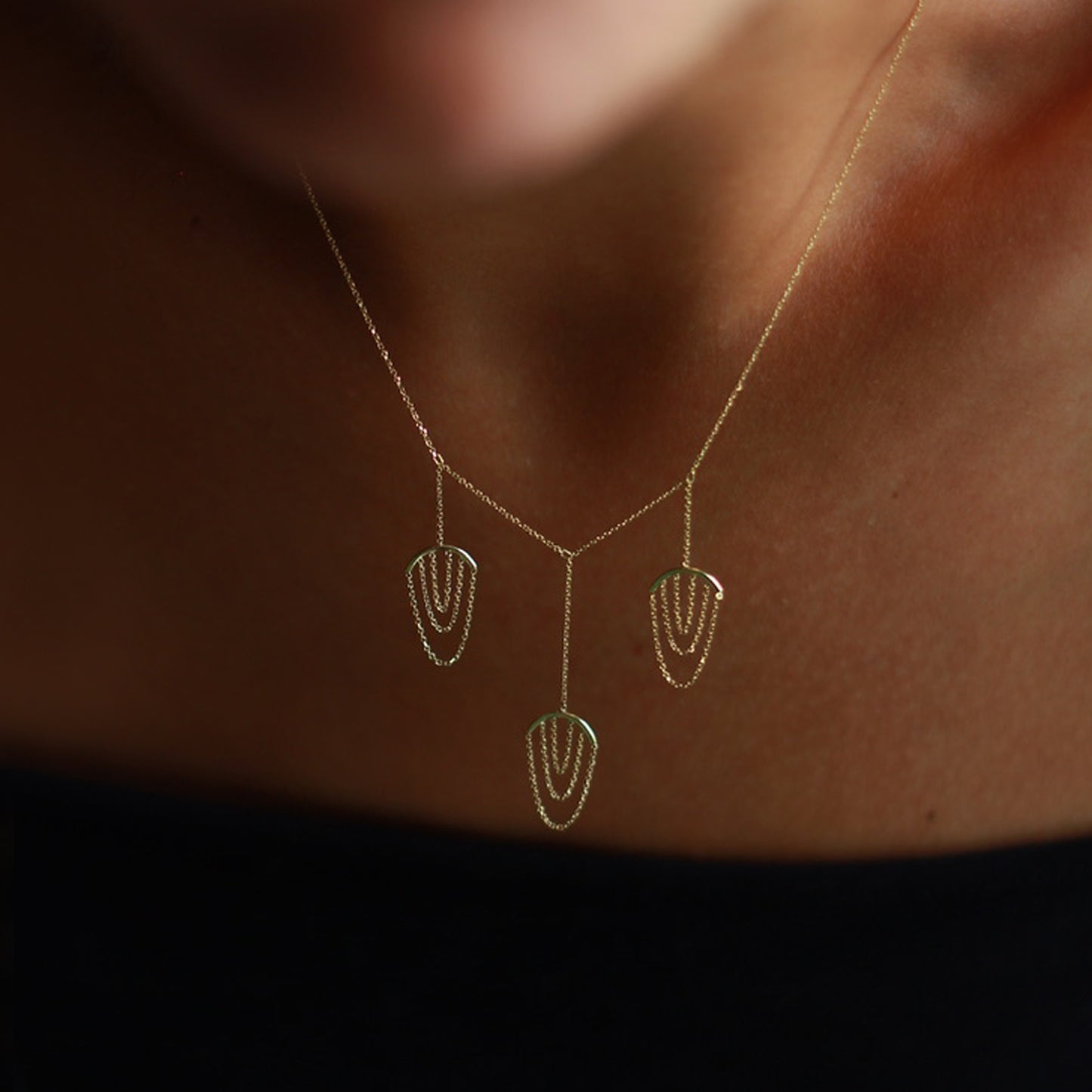 Sweet Pea 18ct yellow gold Nouveau Now triple drop necklace with looped chains on model. 
