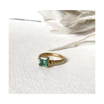 Ruth Tomlinson 18ct yellow gold ring with square facetted solitaire emerald with beaded granulation surround engagement ring. Alternative engagement ring. Organic emerald ring.  