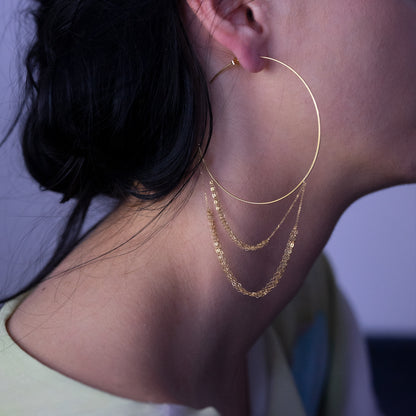 18ct yellow gold hoop with looped layered chains on model