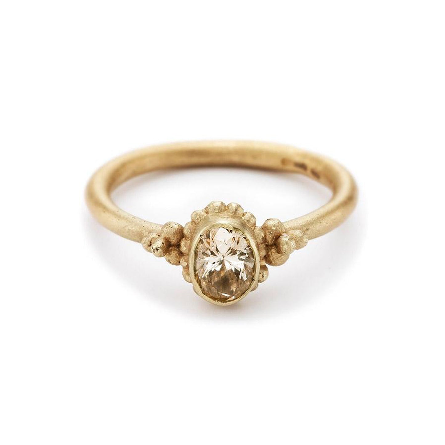14ct yellow gold Ruth Tomlinson oval Champagne Diamond solitaire ring in bezel setting with granulation bead detail. Alternative engagement ring.