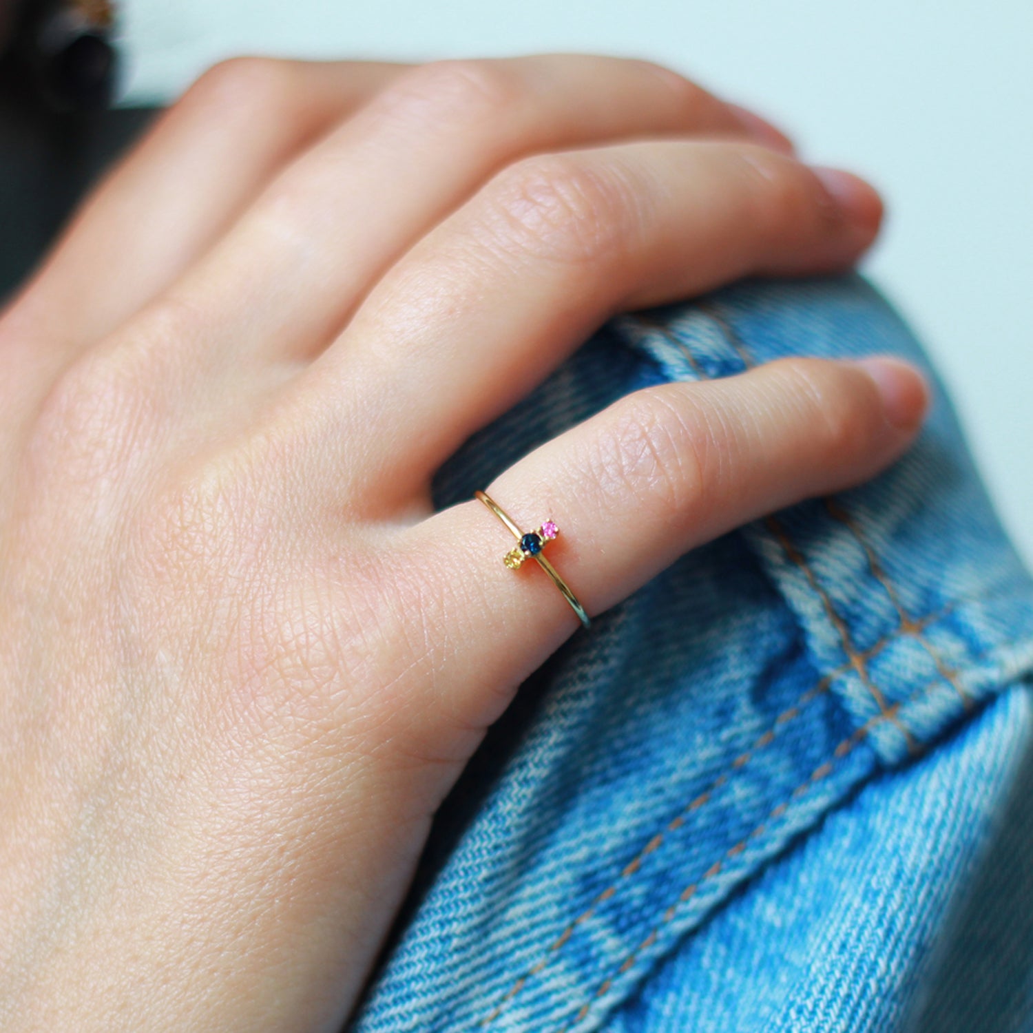 18ct yellow gold ring with yellow blue and pink set Sapphires on model
