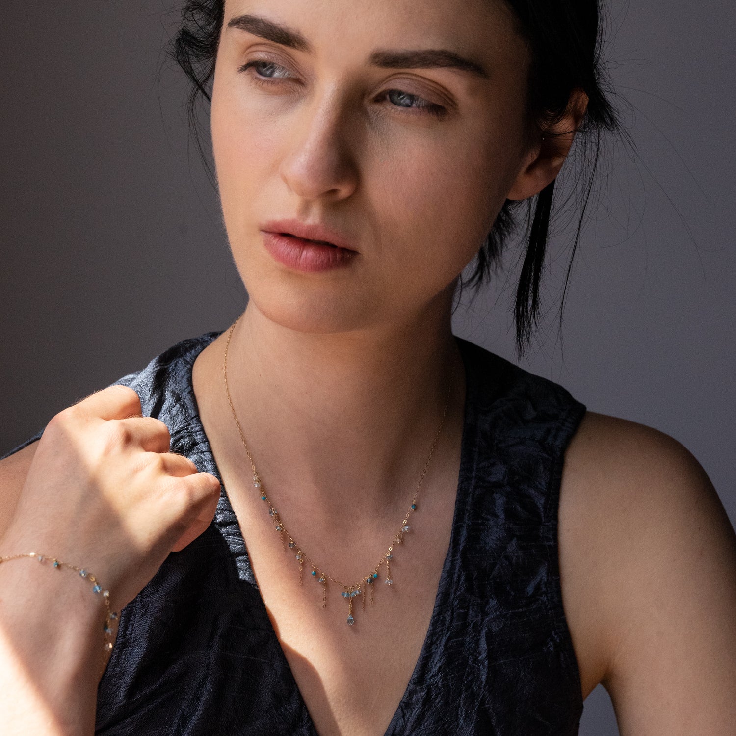 18ct yellow gold chain necklace with hanging beads and chains on model