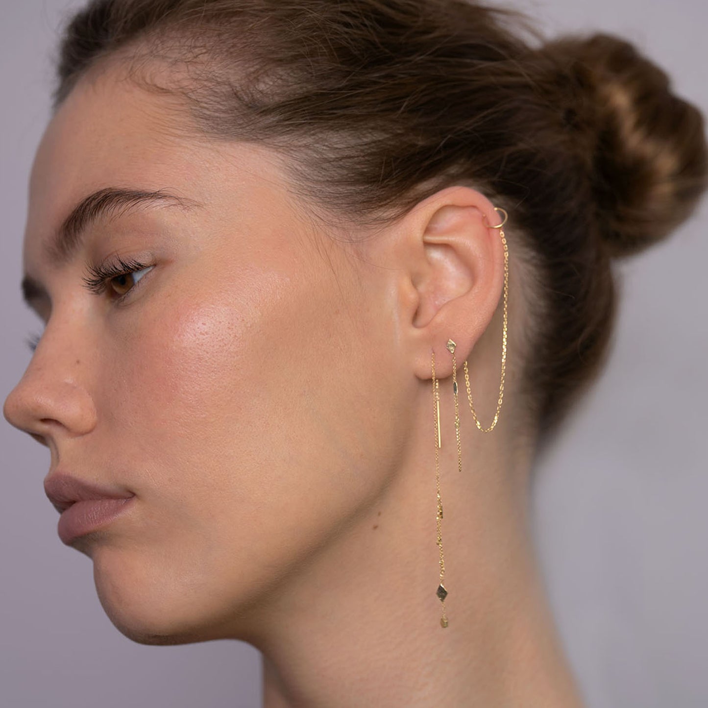 18ct Gold thread through earrings with mixed gold shaped and chains on model