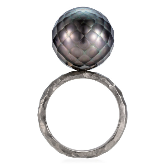 18ct white gold ring with faceted black Tahitian Pearl floating on a chunky hammered band