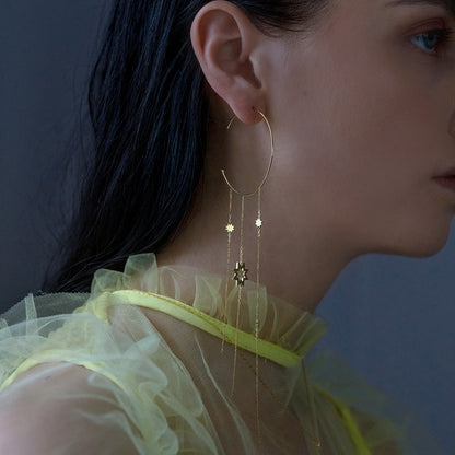 Sweet Pea 18ct yellow gold Reach For The Stars large hoop earring on model. Star and chain hanging large hoop earring on model.