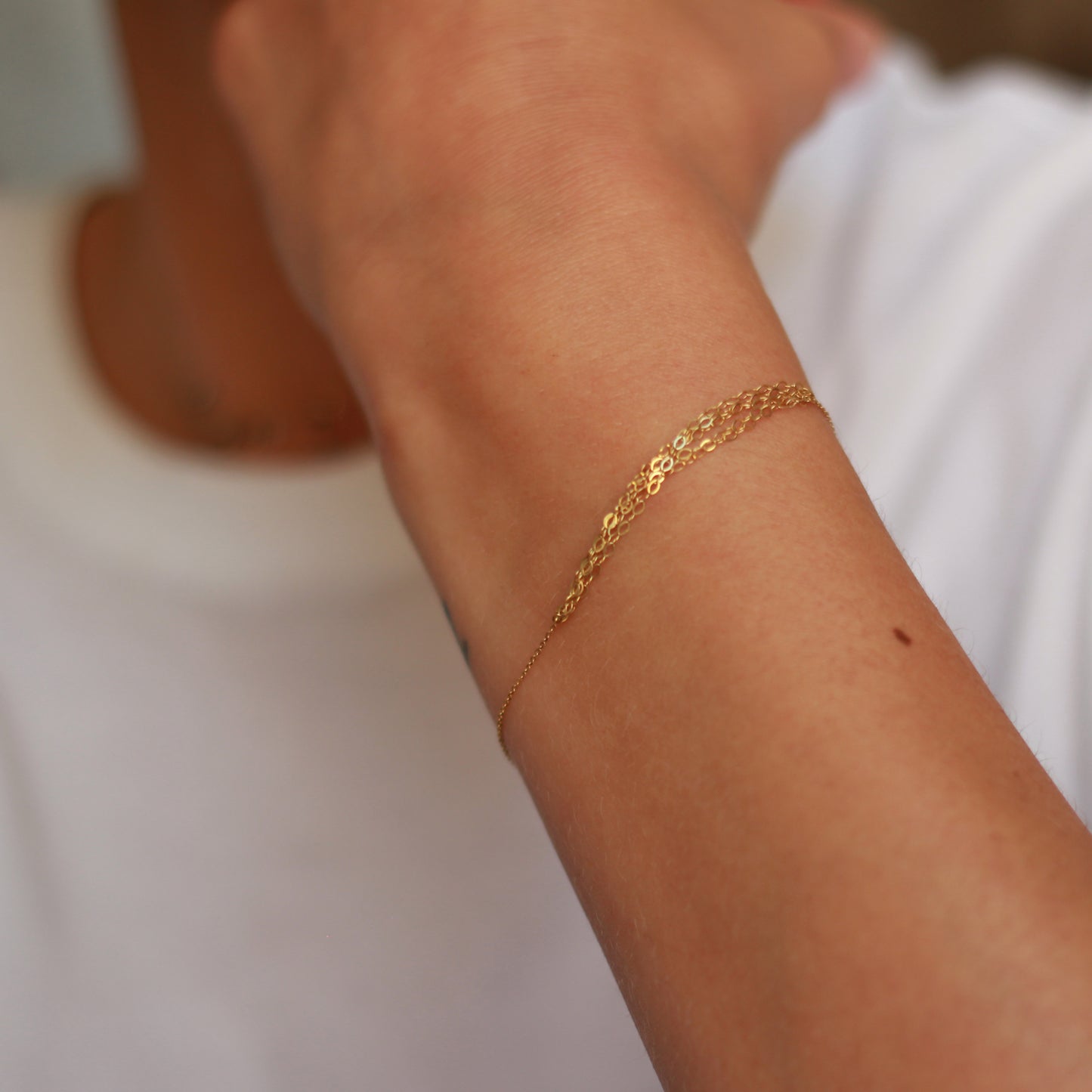 18ct yellow gold bracelet with layered chain section on model
